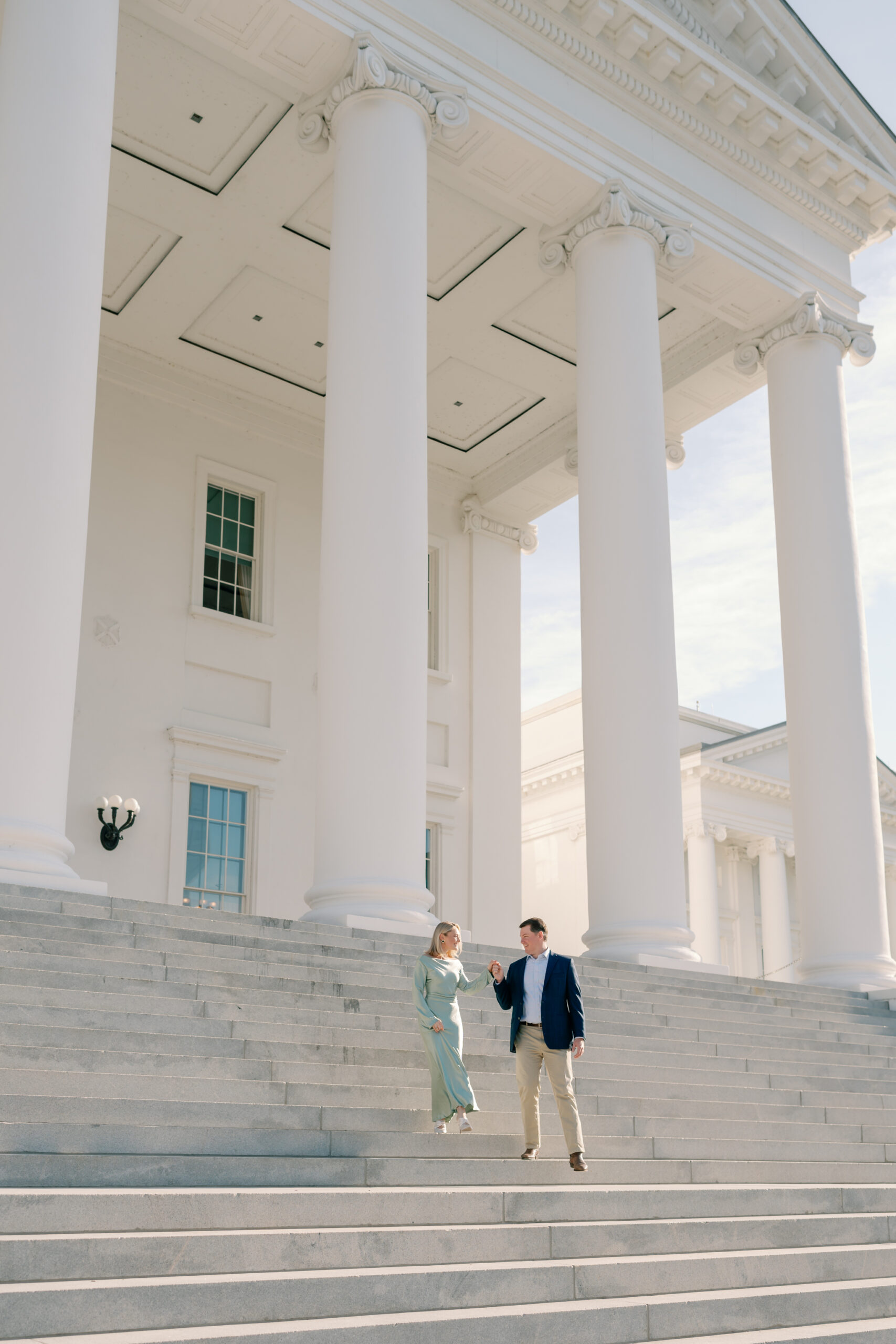 An engaged couple at the Virginia Capitol Building, a classic Richmond engagement location