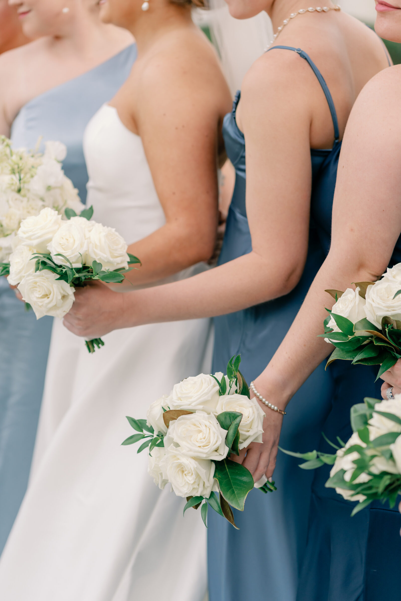 Williamsburg Inn Wedding in Williamsburg, VA | Wedding Photographers in VA | bride and bridesmaids in different shades of blue dresses holding white floral bouquets