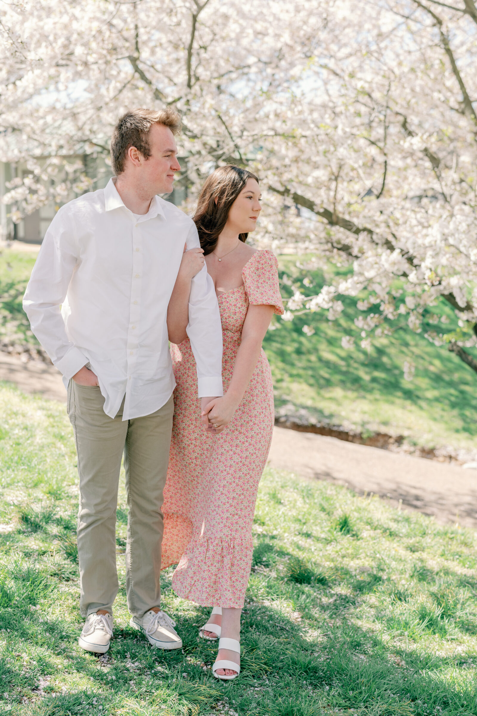 Engagement Session at Belle Isle in Richmond, VA | RVA Engagement Photographer | couple arm in arm amidst the cherry blossoms in Richmond's Belle Isle