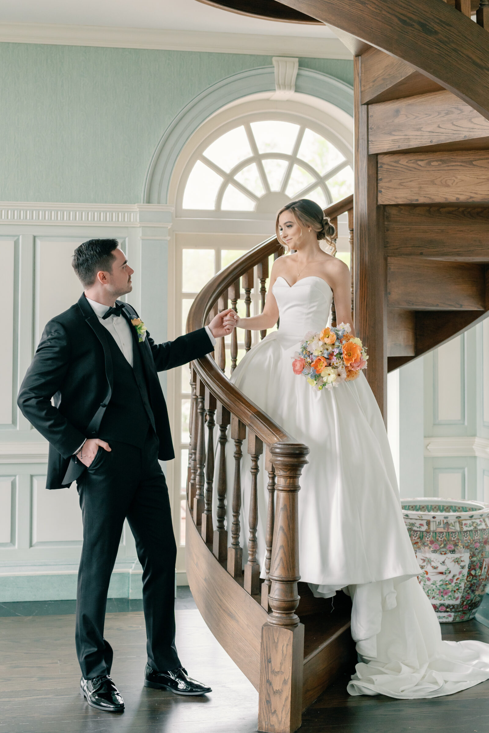 Estate at River Run Wedding in Maidens, VA | Wedding Photographer in Richmond | groom helping his bride down the spiral staircase at the Estate at River Run