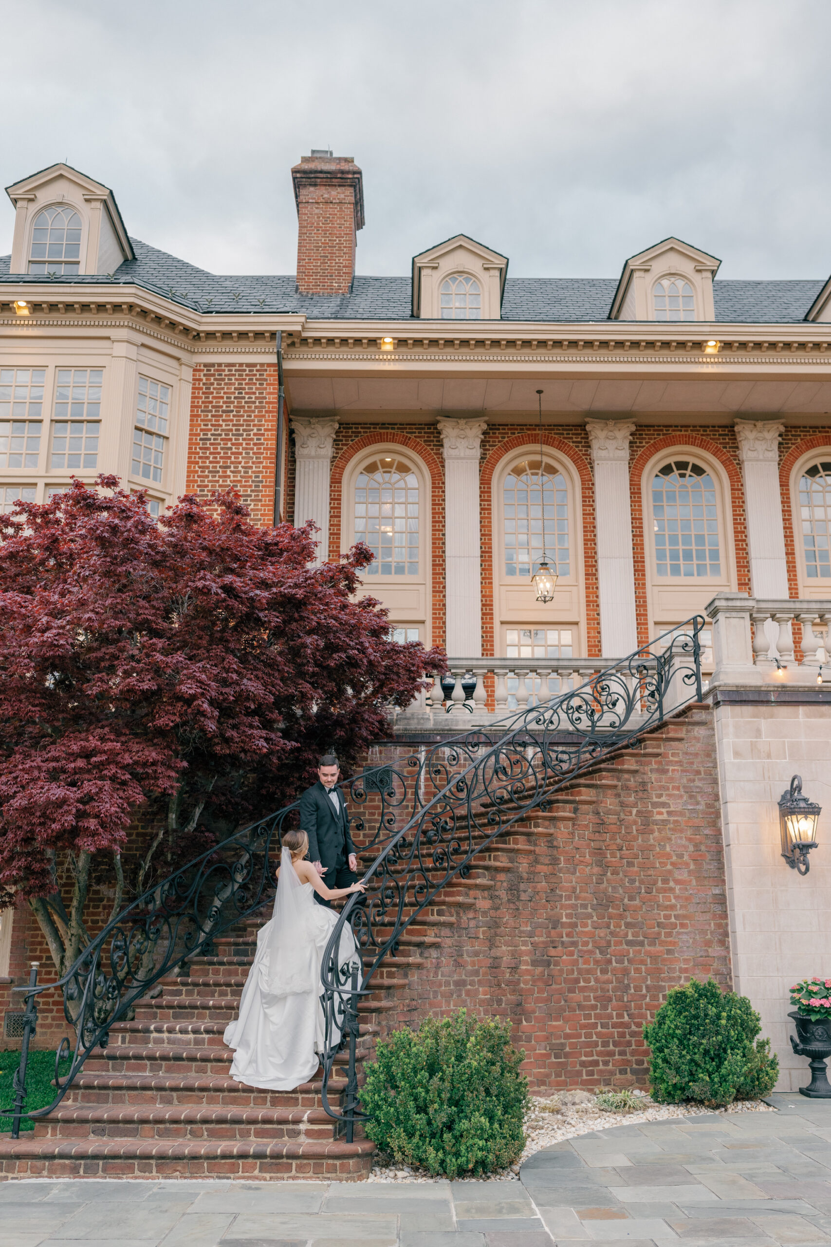 Estate at River Run Wedding in Richmond, VA | Richmond Wedding Photographer | bride and groom walking up the stairs of the outdoor patio at Richmond's Estate at River Run