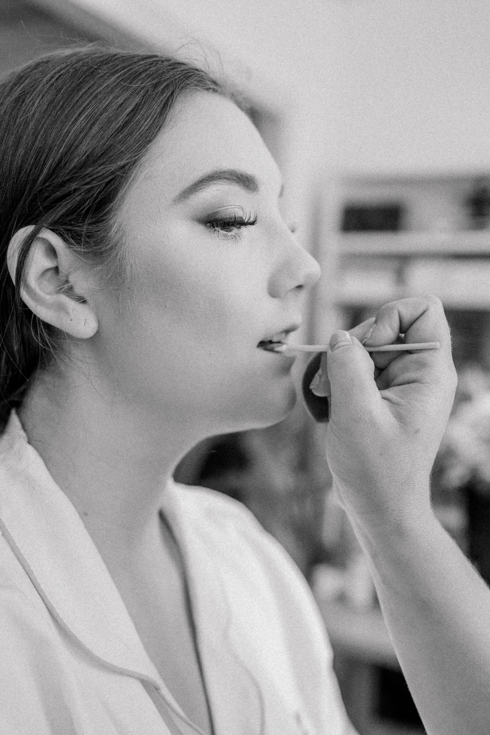 Lynchburg VA Wedding Venue | Three Oaks Manor Wedding in Madison Heights, VA | black and white image of bride getting lipgloss applied to her makeup.