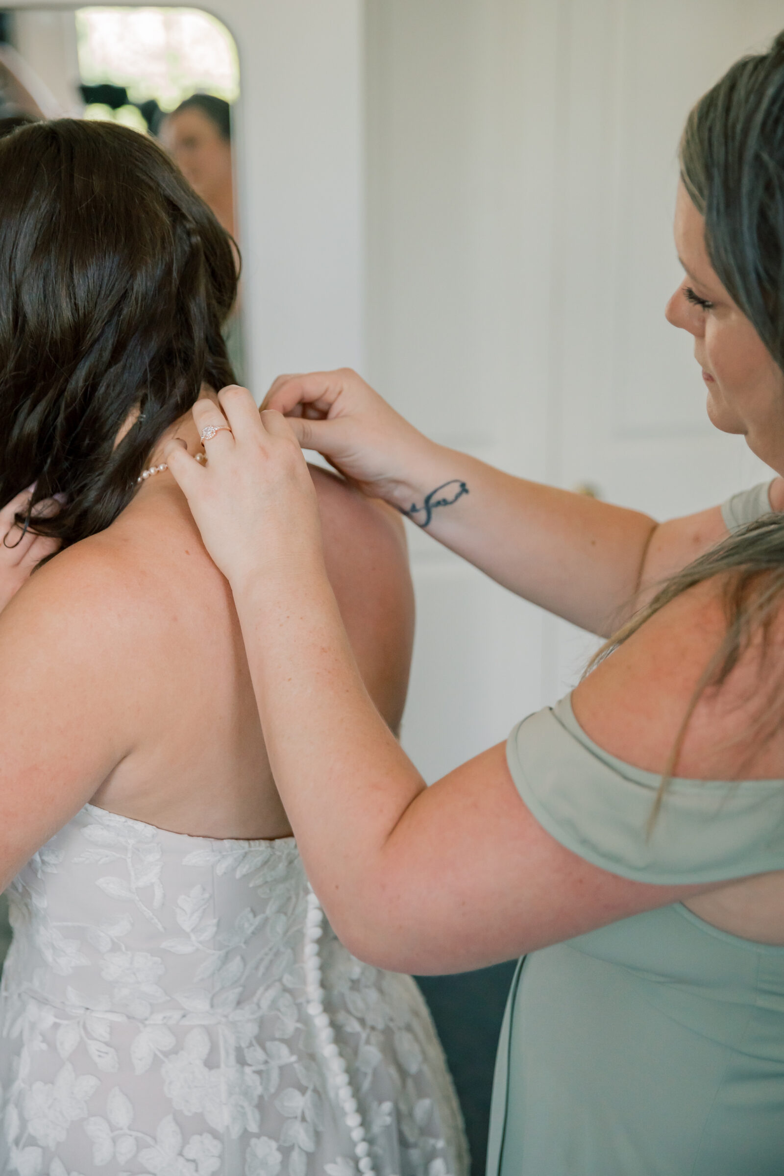 Lynchburg Virginia Wedding Photographer | mother of bride adjusts bride's necklace while getting ready