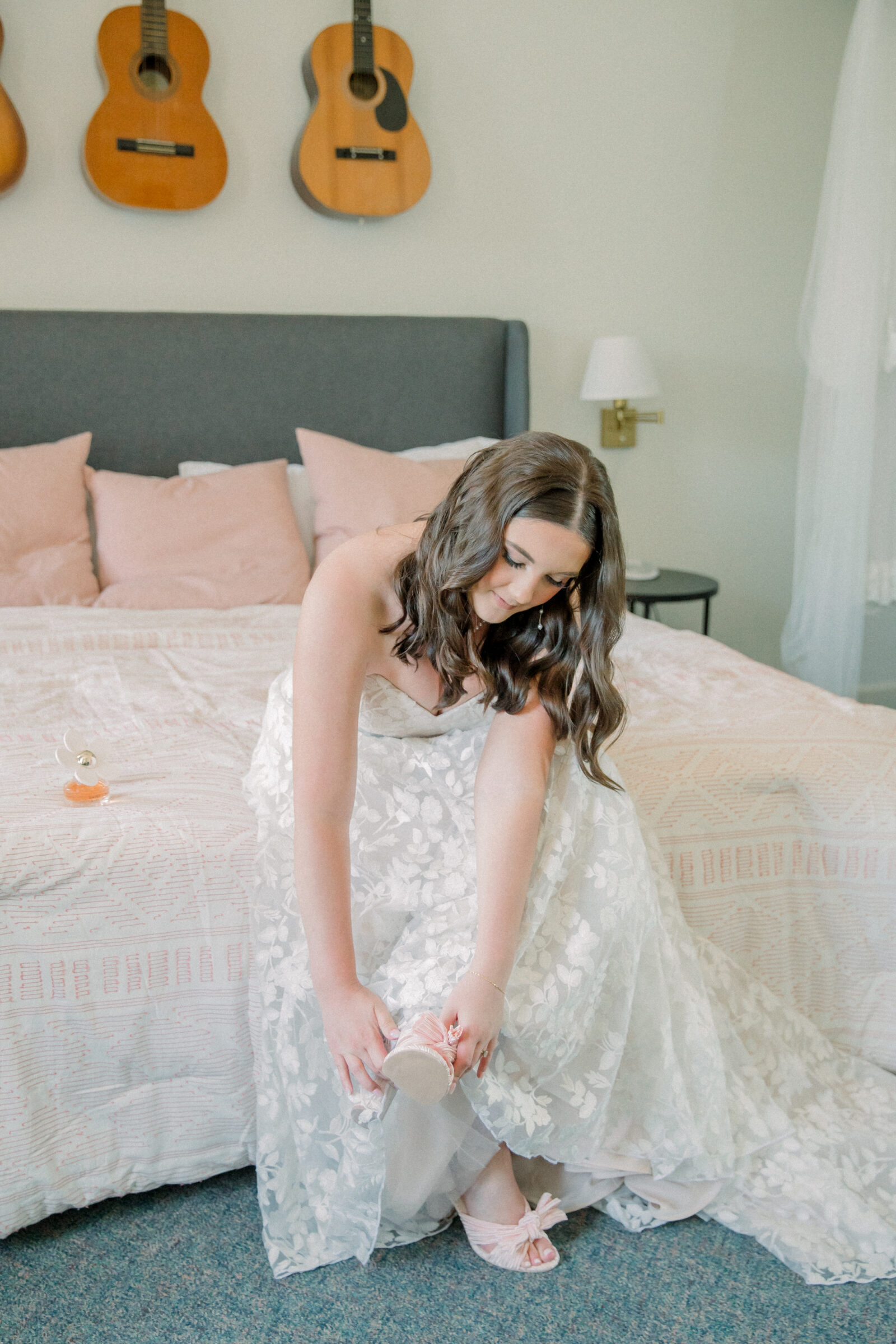 Lynchburg Virginia Wedding Photographer | bride in white floral wedding dress puts on pink shoes with a bow while getting ready for her Virginia wedding