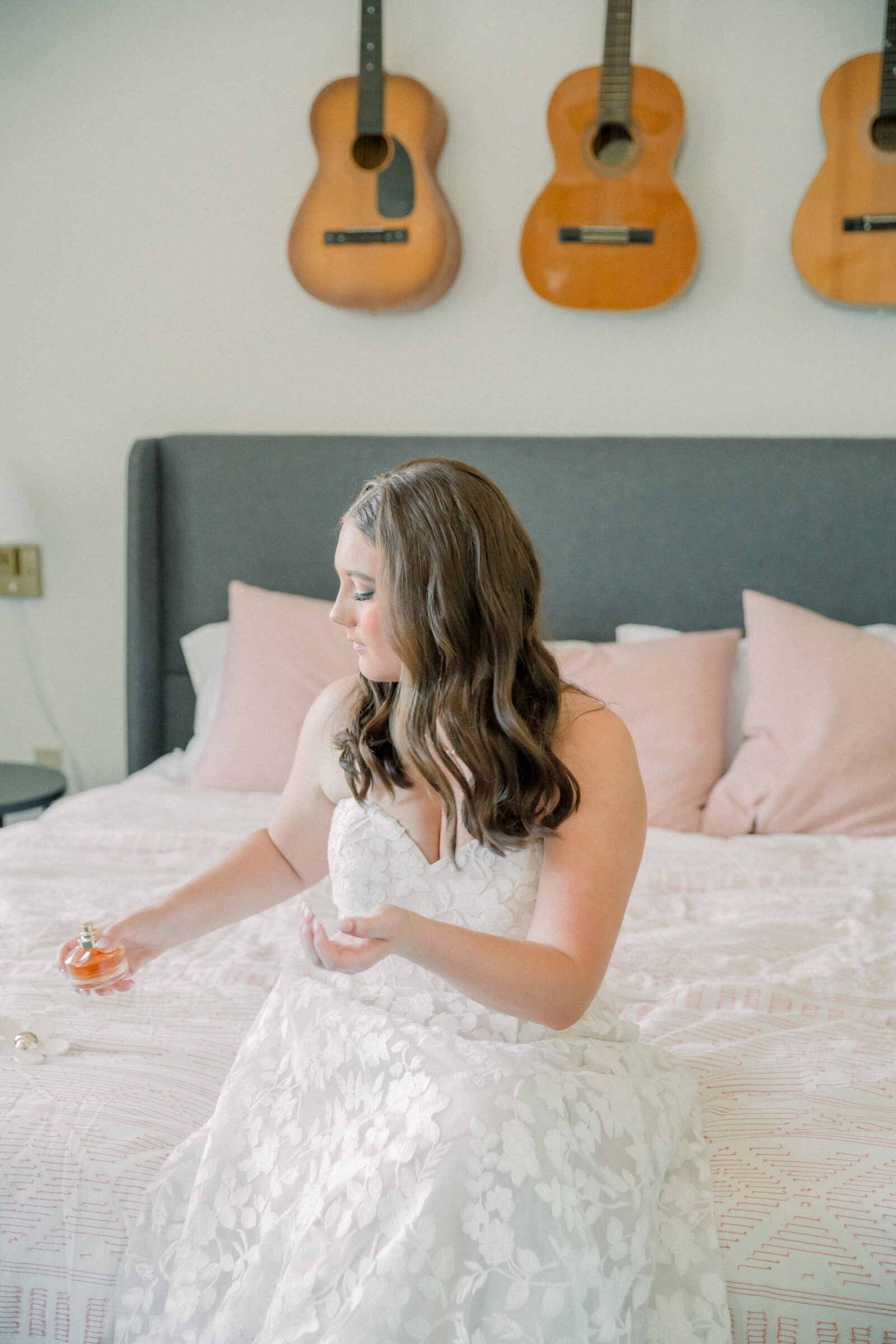 Lynchburg Virginia Wedding Photographer | bride in a strapless floral dress applies her Daisy by Marc Jacobs perfume while getting ready for her Virginia wedding at Three Oaks Manor