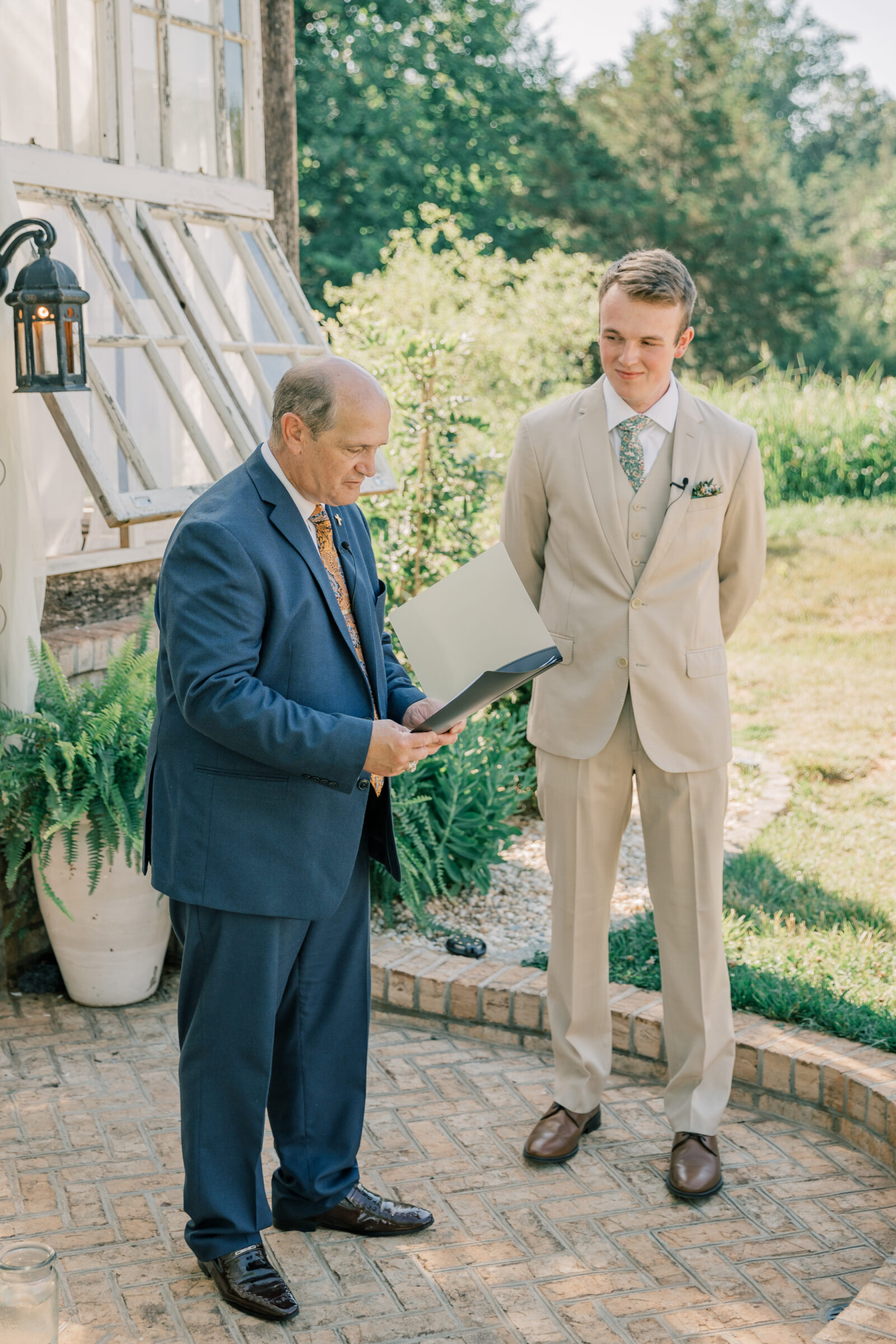 Three Oaks Manor Wedding in Madison Heights, VA | Virginia Wedding Photographer | pastor in navy suit and groom in tan suit wait at the alter before bride walks down the aisle