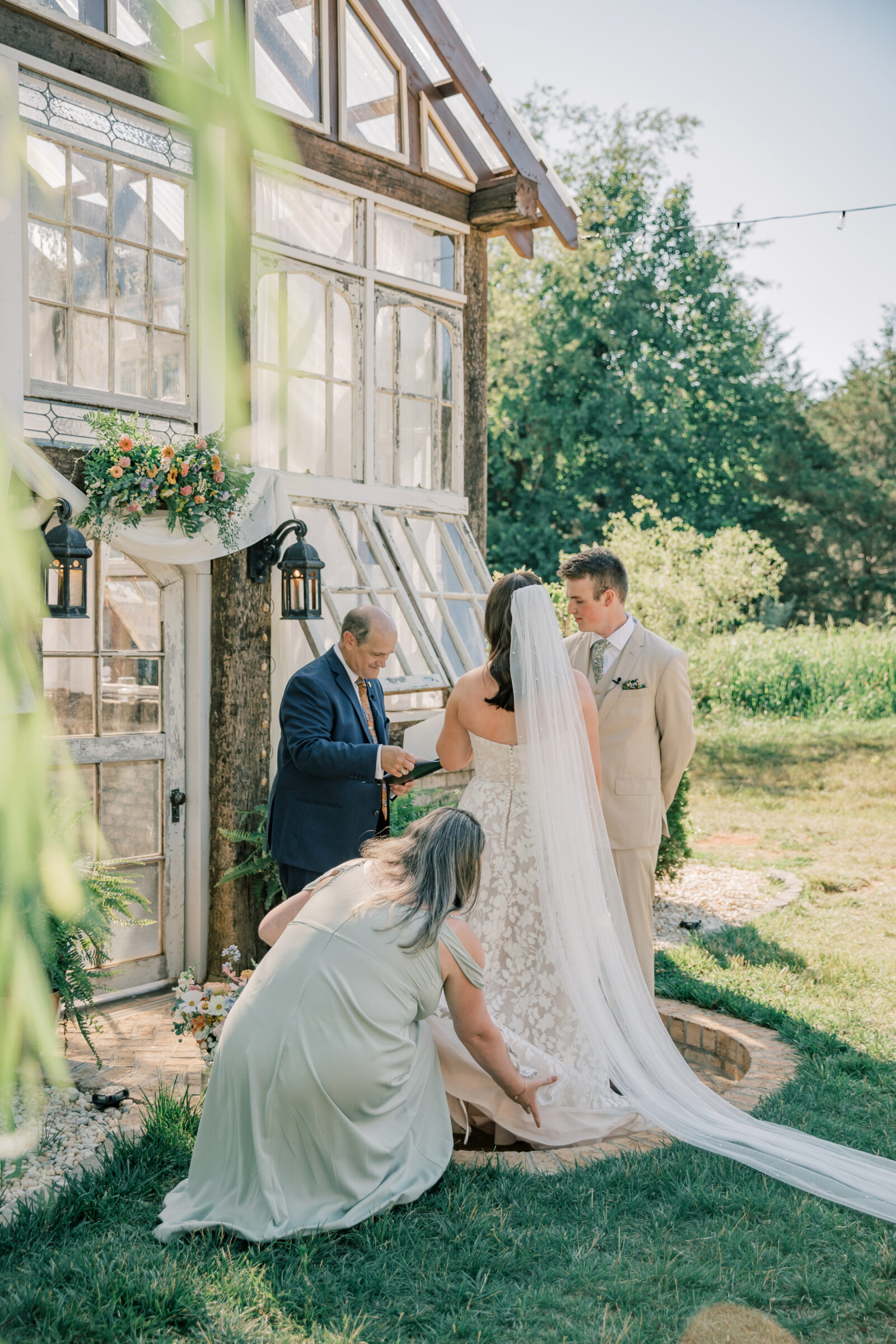 Three Oaks Manor Wedding in Madison Heights, VA | Virginia Wedding Photographer | mother of bride fluffs the train of bride's dress during wedding ceremony