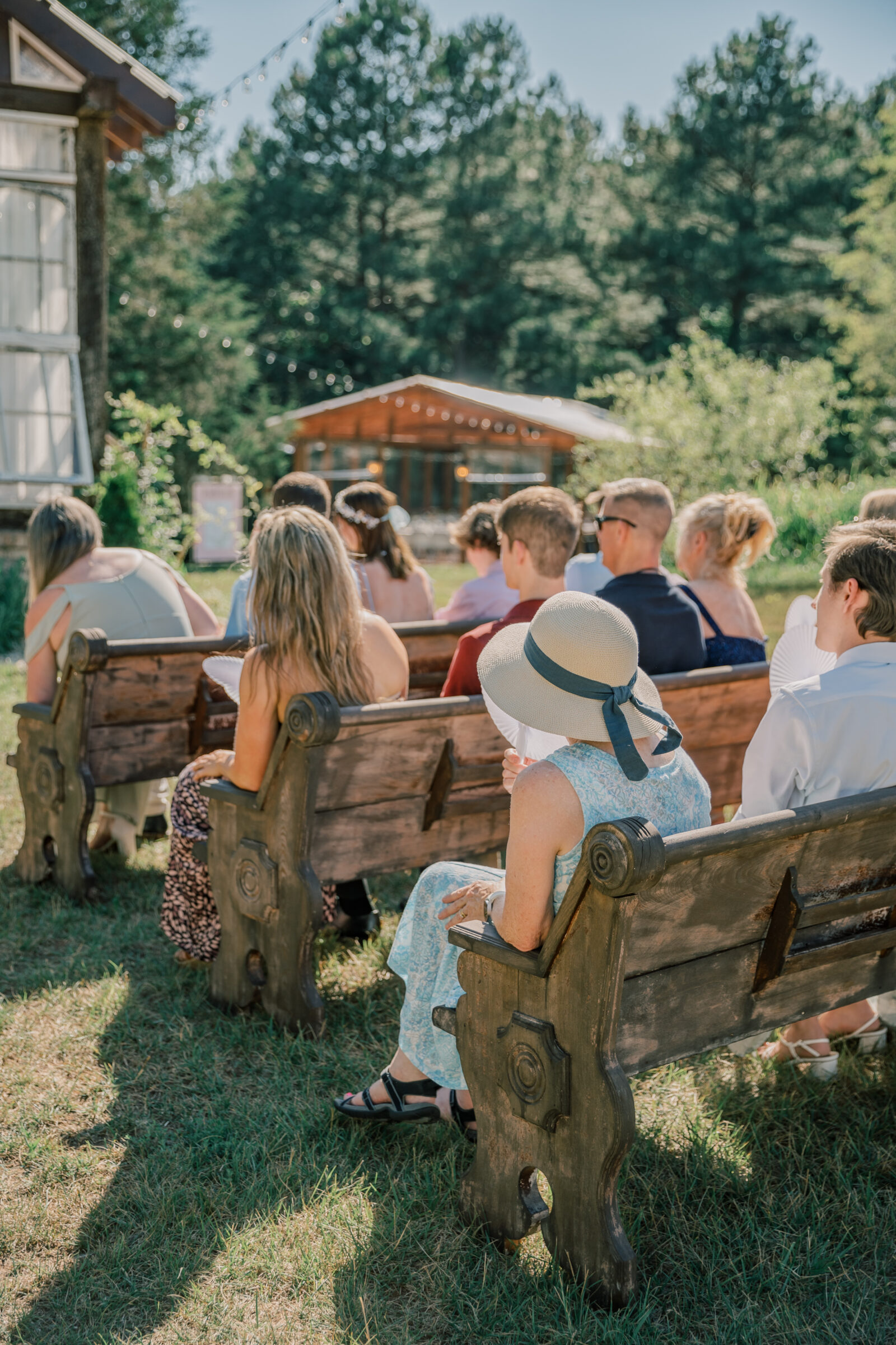 Three Oaks Manor Wedding in Madison Heights, VA | Virginia Wedding Photographer | guests seated in wooden pews during wedding ceremony