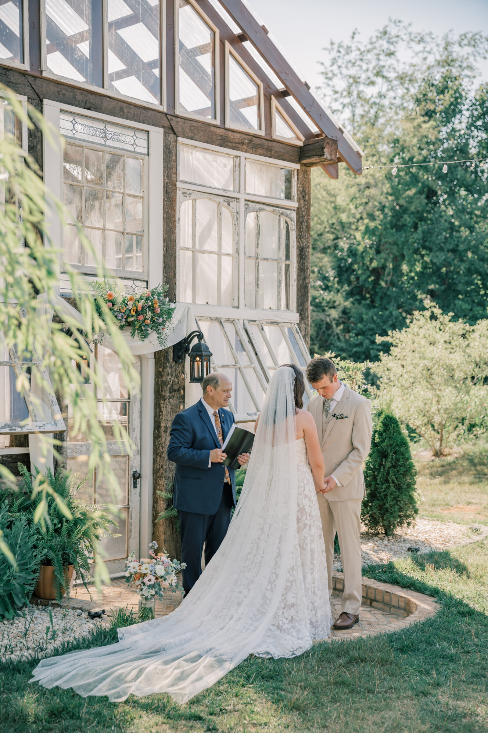 Three Oaks Manor Wedding in Madison Heights, VA | Virginia Wedding Photographer | bride and groom pray together during wedding ceremony at Three Oaks Manor