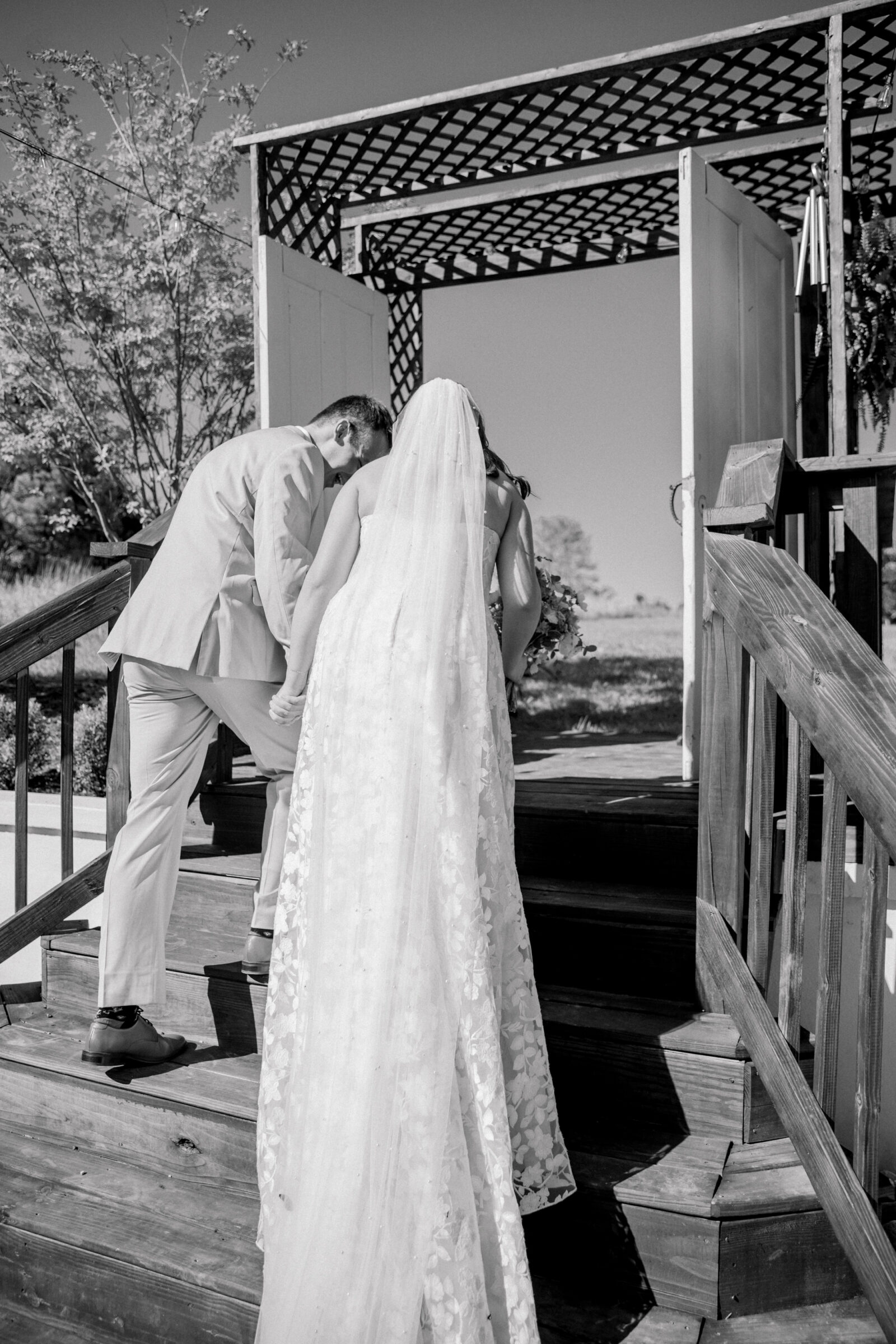 Three Oaks Manor Wedding in Madison Heights, VA | Virginia Wedding Photographer | black and white image of bride and groom walking away from their ceremony site