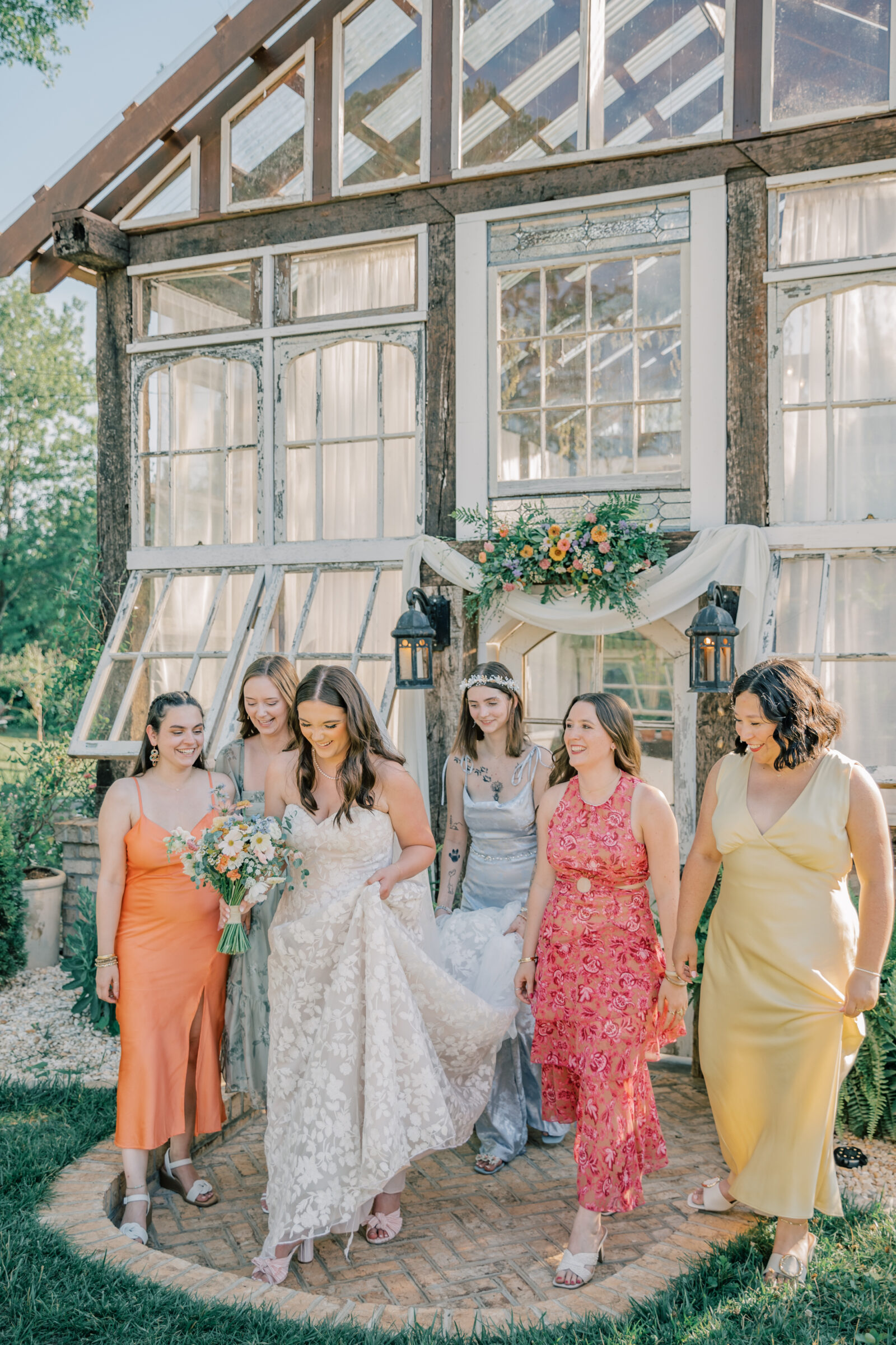 Three Oaks Manor Wedding in Madison Heights, VA | Virginia Wedding Photographer | bridesmaids help hold bride's dress as they walk