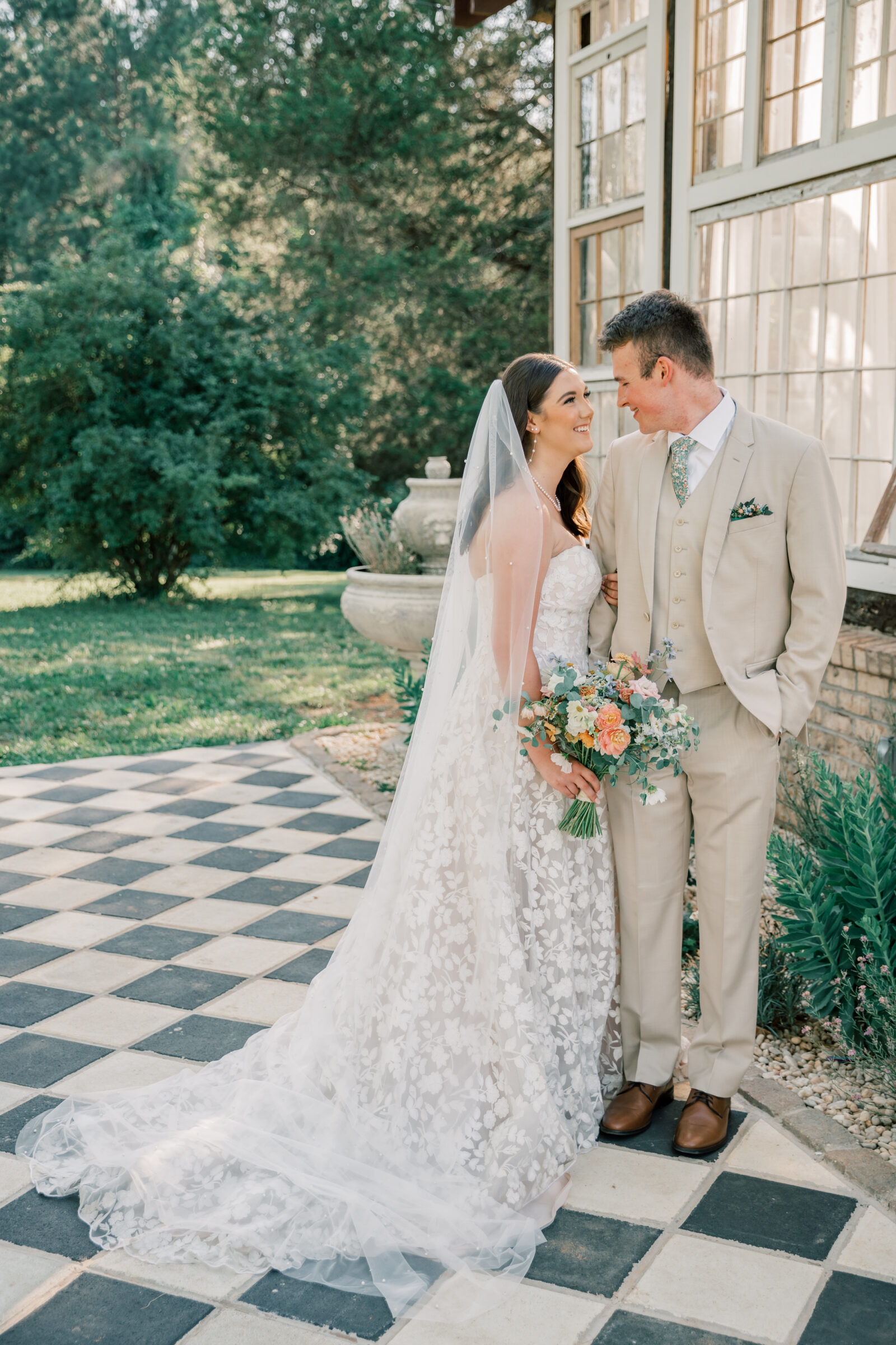 Three Oaks Manor Wedding in Madison Heights, VA | Virginia Wedding Photographer | bride and groom look lovingly into each other's eyes outside of the greenhouse at Three Oaks Manor