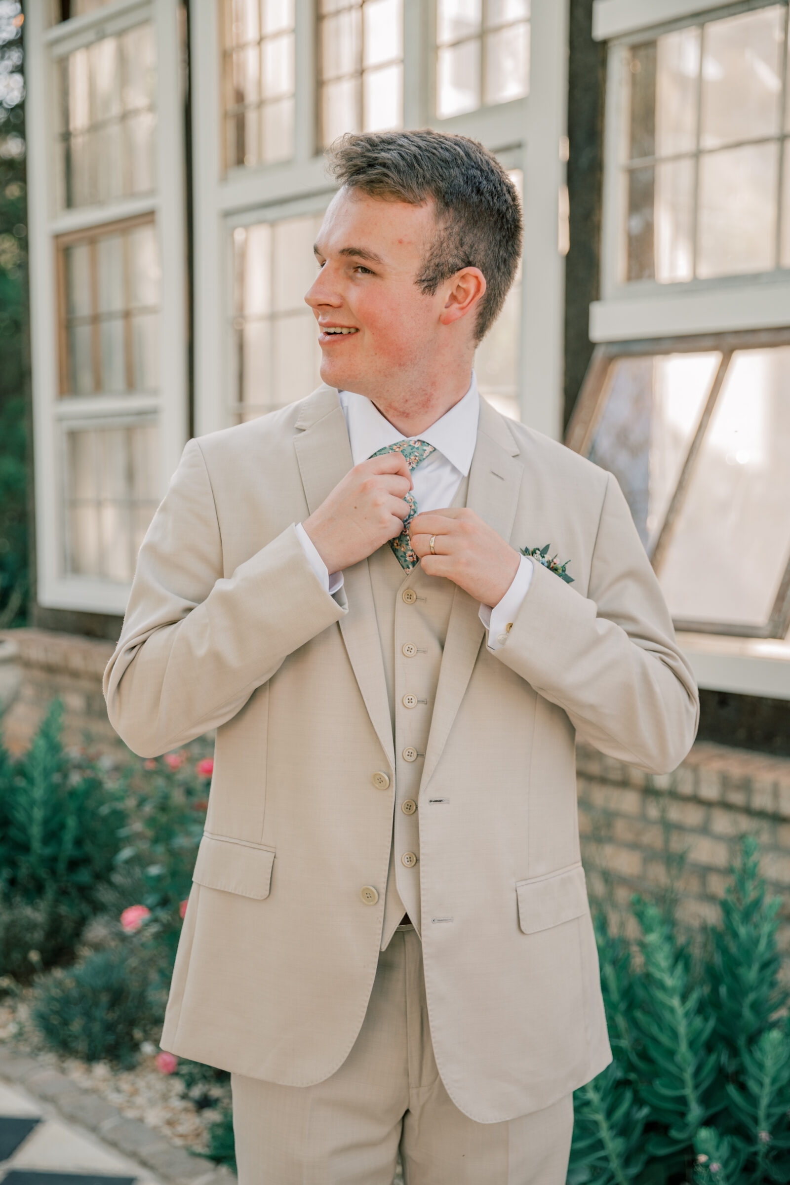 Three Oaks Manor Wedding in Madison Heights, VA | groom in tan suit adjusts tie