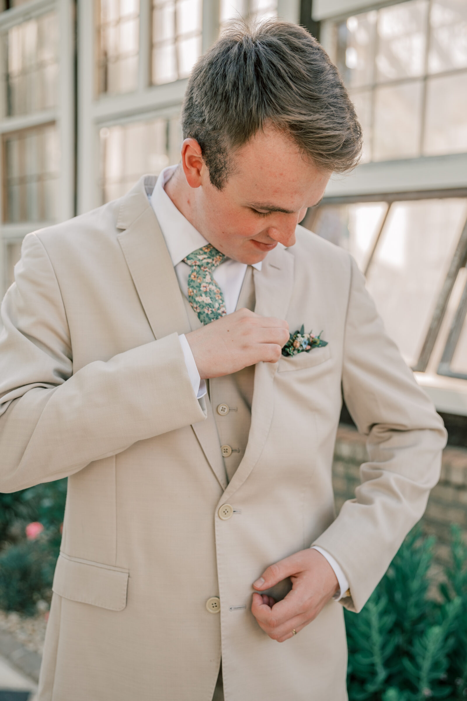 Three Oaks Manor Wedding in Madison Heights, VA | groom in tan suit adjusts his pocket square boutonniere 