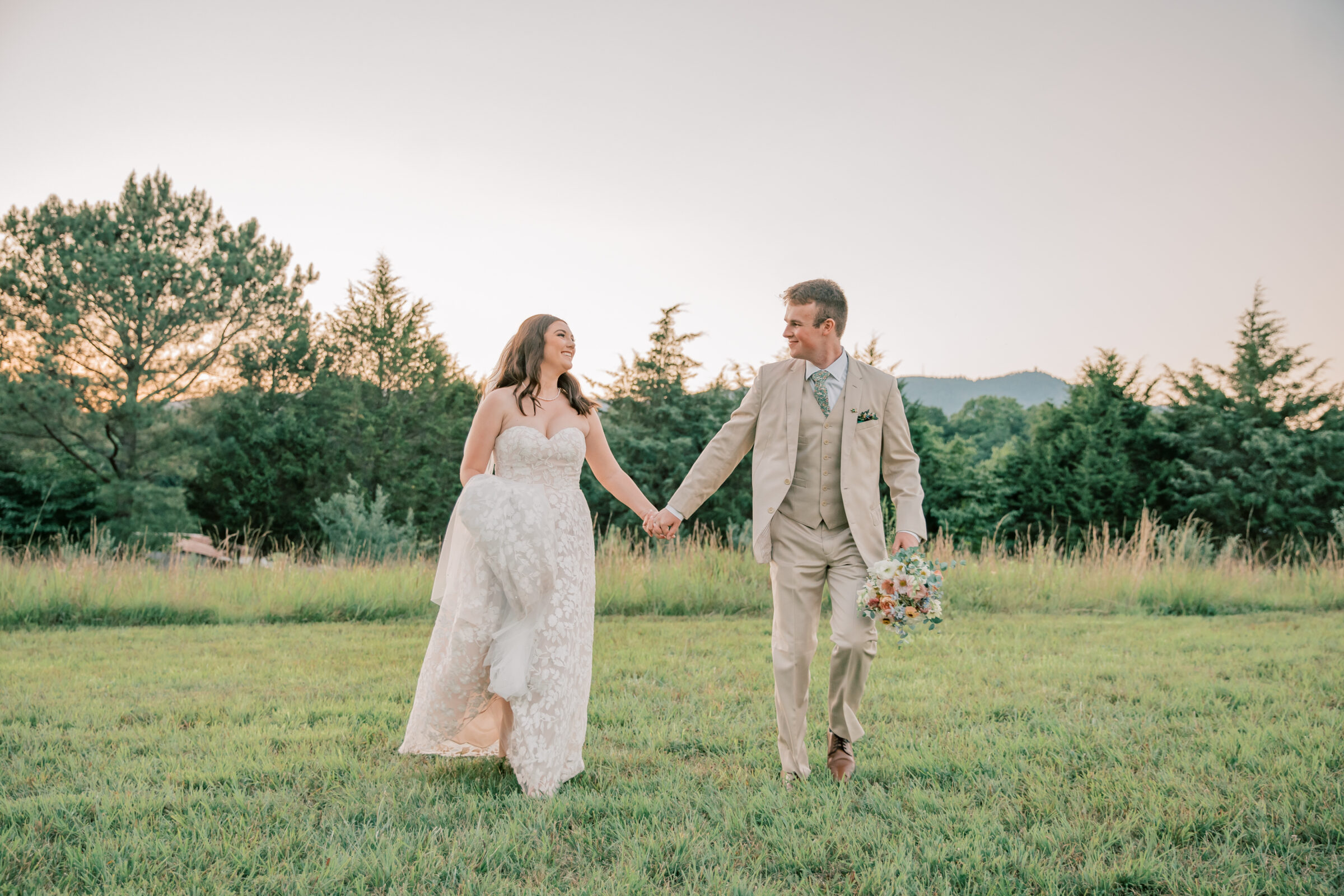 Three Oaks Manor Wedding in Madison Heights, VA | Virginia Wedding Photographer | bride and groom run hand in hand through the field at Three Oaks Manor