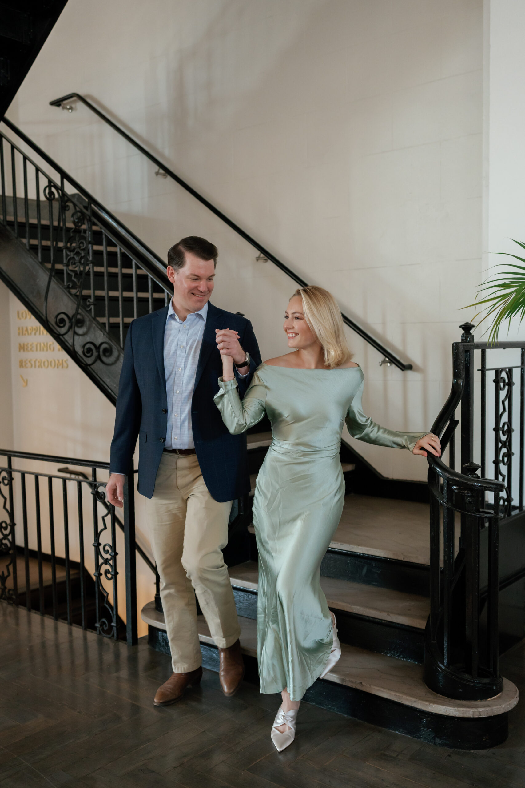 Quirk Hotel RVA Engagement Session in Richmond, VA | Wedding Photographer in Richmond | couple walking down the stairs at the Quirk Hotel in Richmond