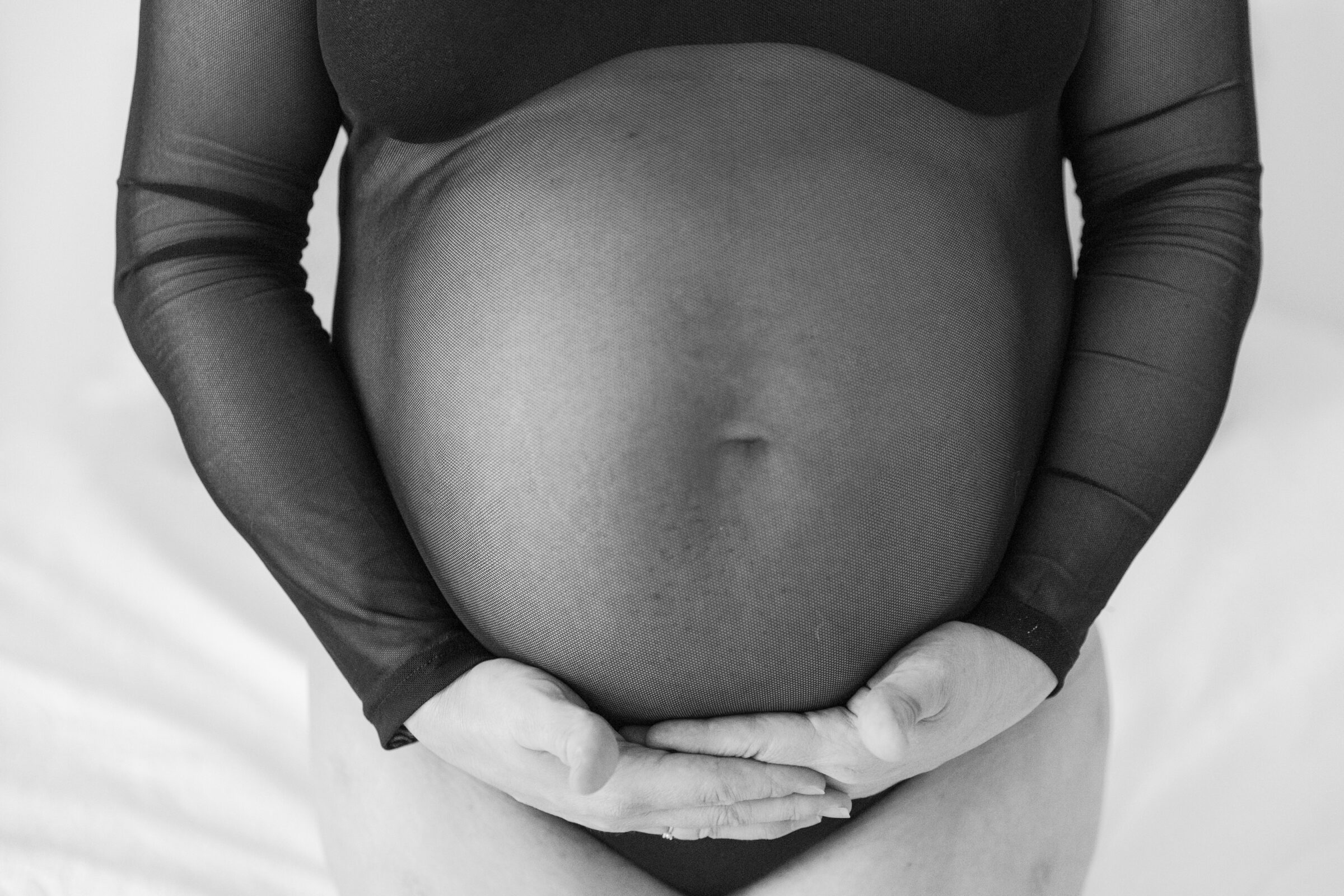 Richmond VA Maternity Boudoir Session | black and white image of pregnant woman cradling her baby bump