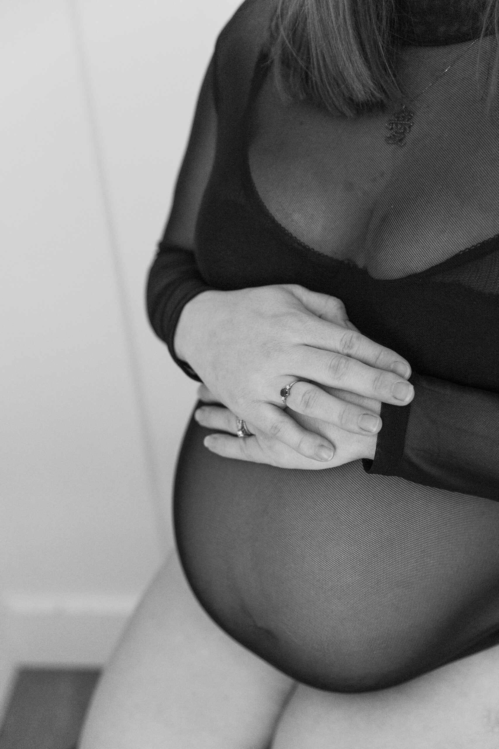 Elegant Maternity Boudoir in Richmond VA | black and white image of pregnant woman with hands on stomach