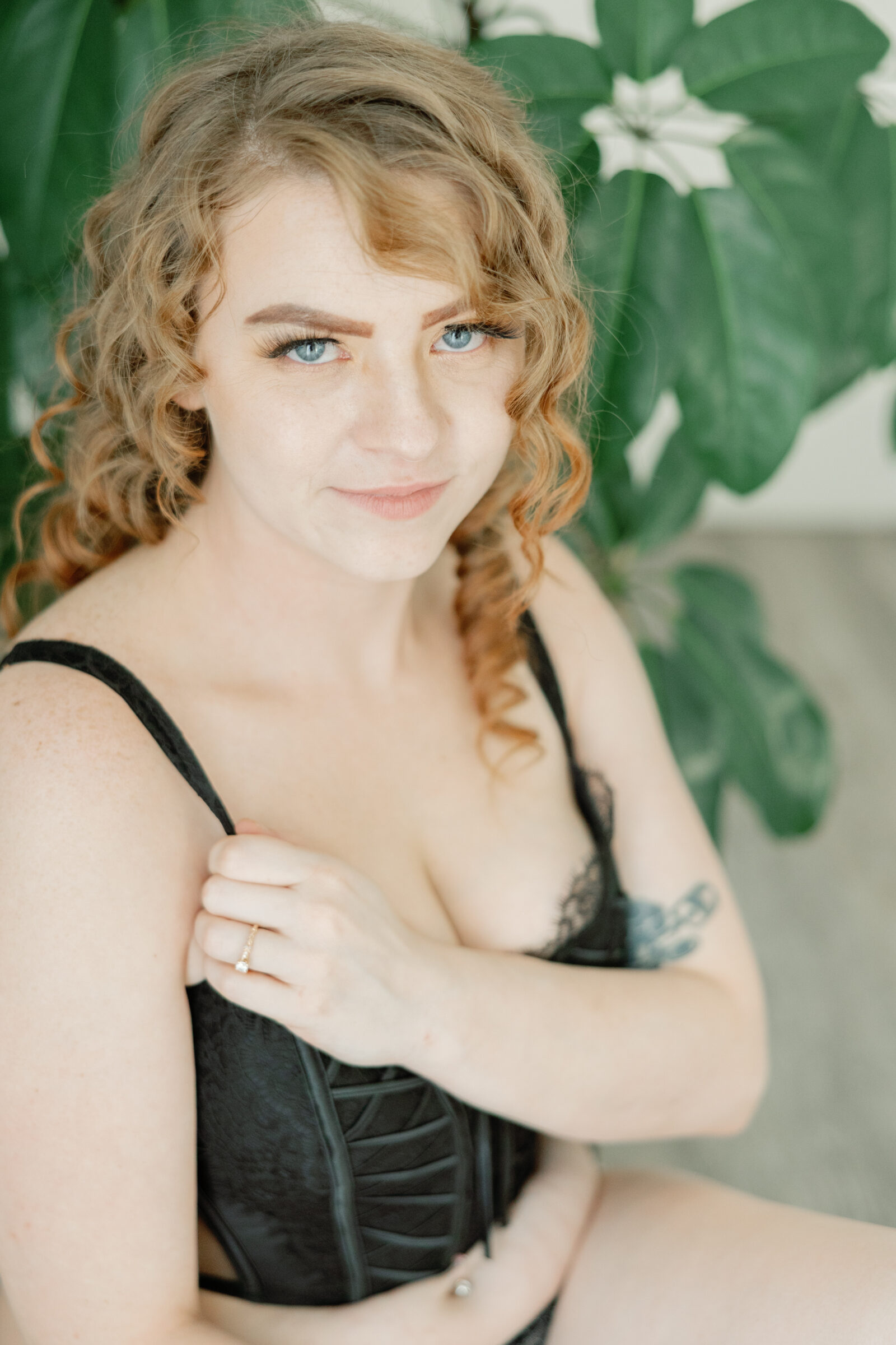 girl in black corset top looks into camera