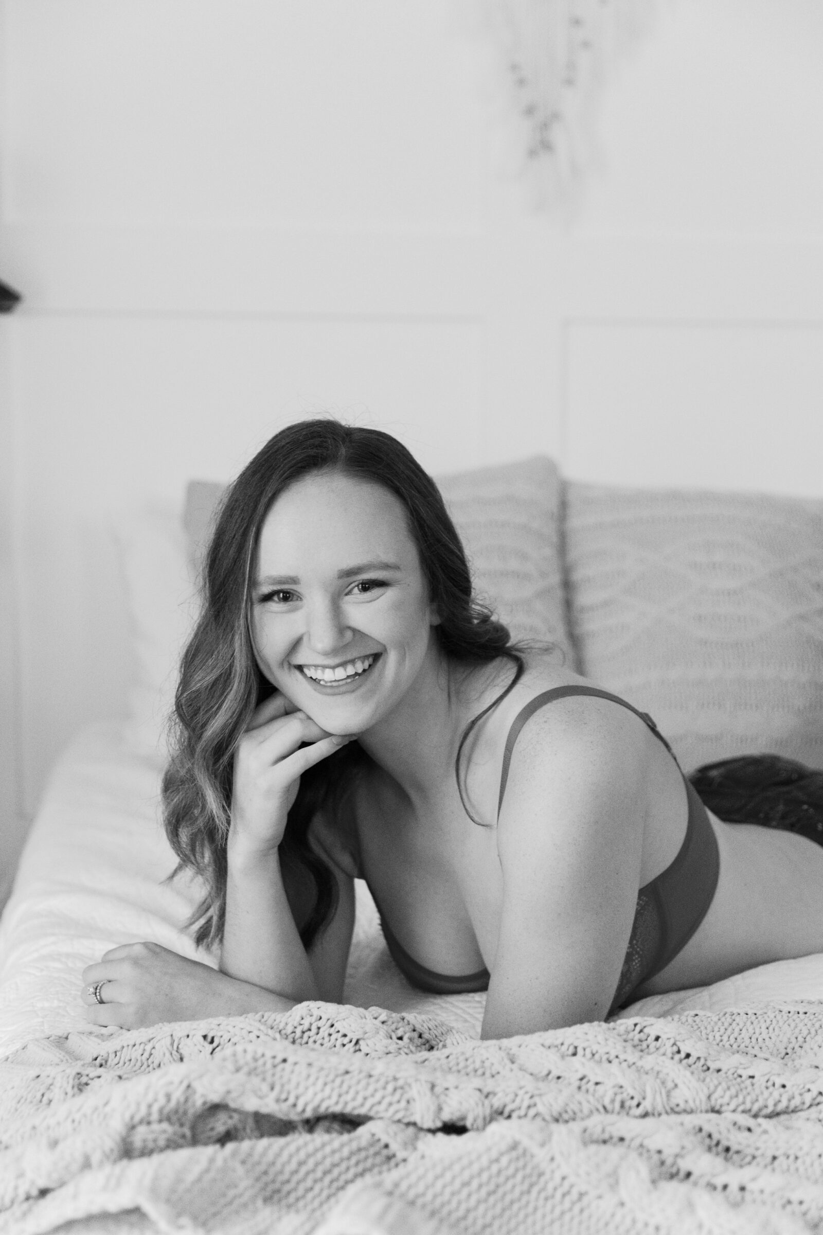 Winter Boudoir Session in Richmond VA | black & white image of girl laying on a bed in Carbone Studios