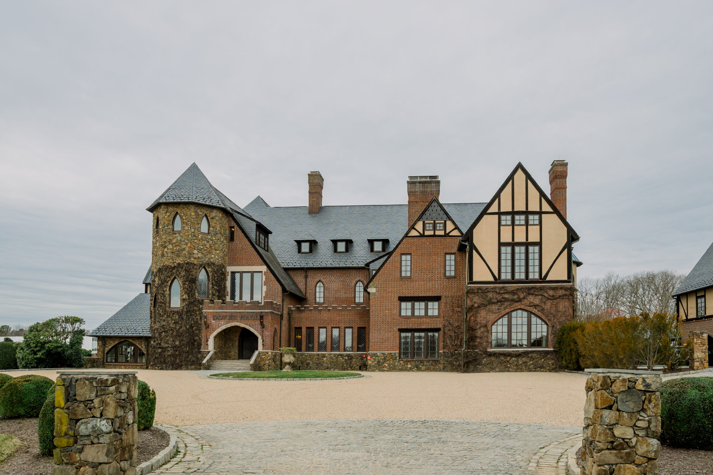 The stunning exterior of Dover Hall, a breathtaking wedding venue in Richmond, VA, showcasing its grand, castle-like architecture and beautiful stonework, perfect for a luxurious wedding celebration.