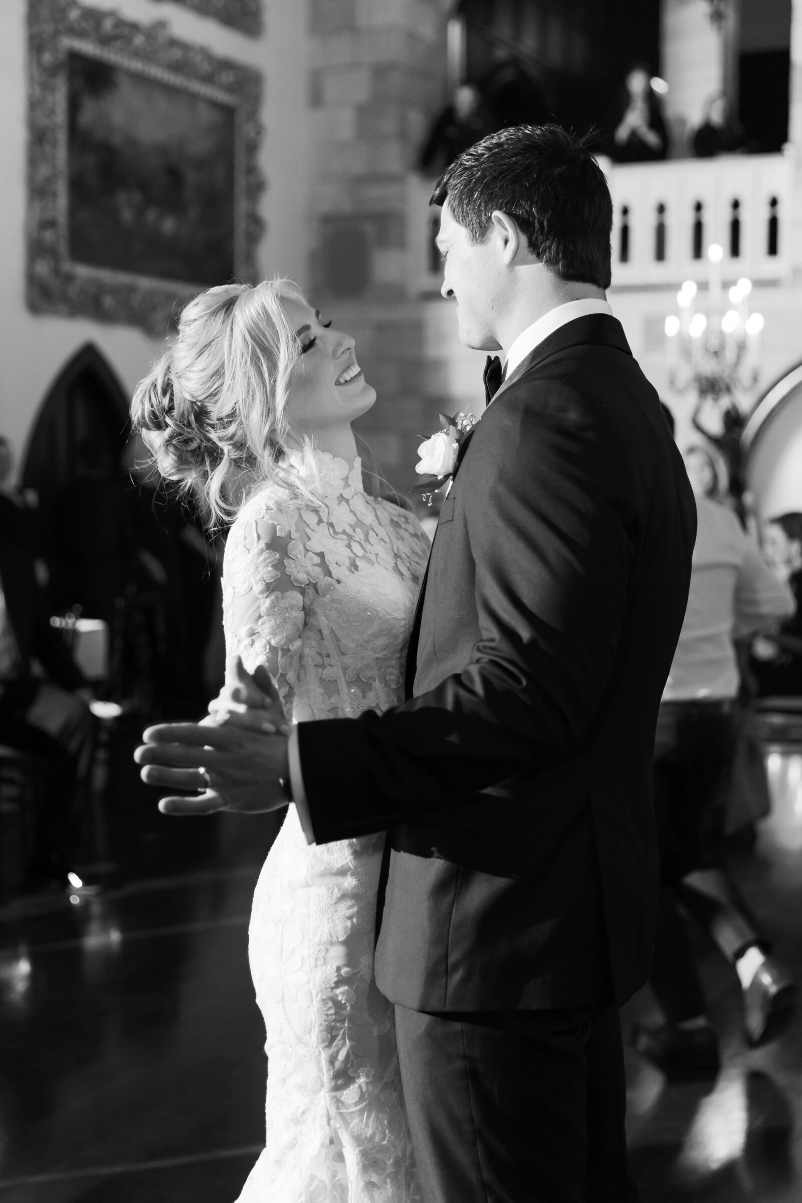A joyful moment captured during the first dance at a Dover Hall Richmond VA wedding. The bride and groom smile lovingly at each other, surrounded by a breathtaking, romantic atmosphere.