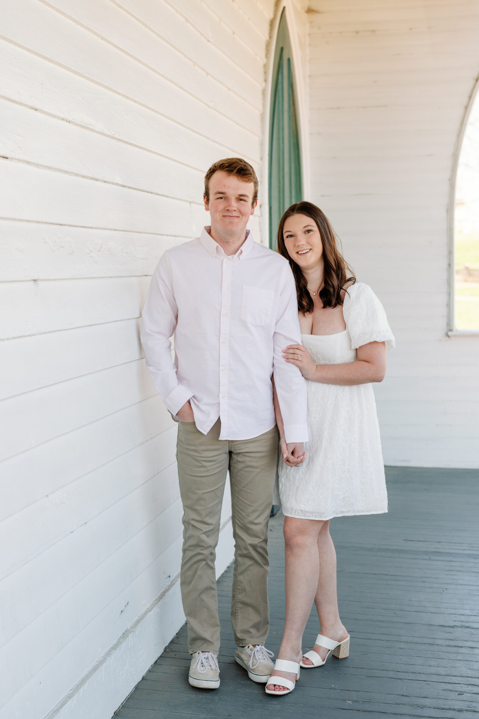 Engagement Session at the VMFA in Richmond VA | couple stand holding hands against a white wall