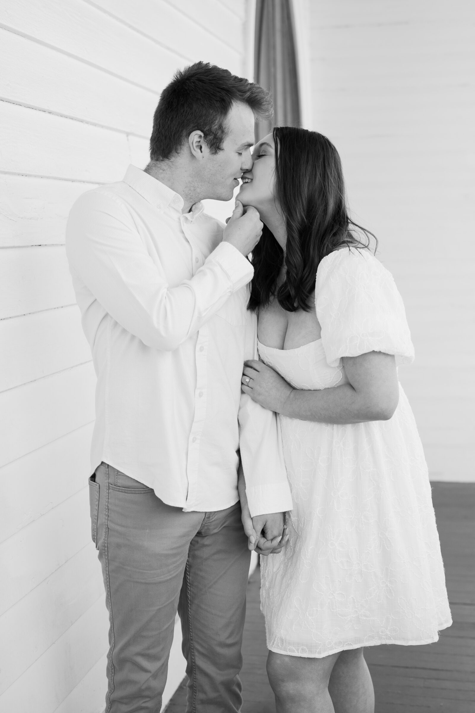 Engagement Session at the VMFA in Richmond VA | groom lifts his soon-to-be-wife's chin for a romantic kiss