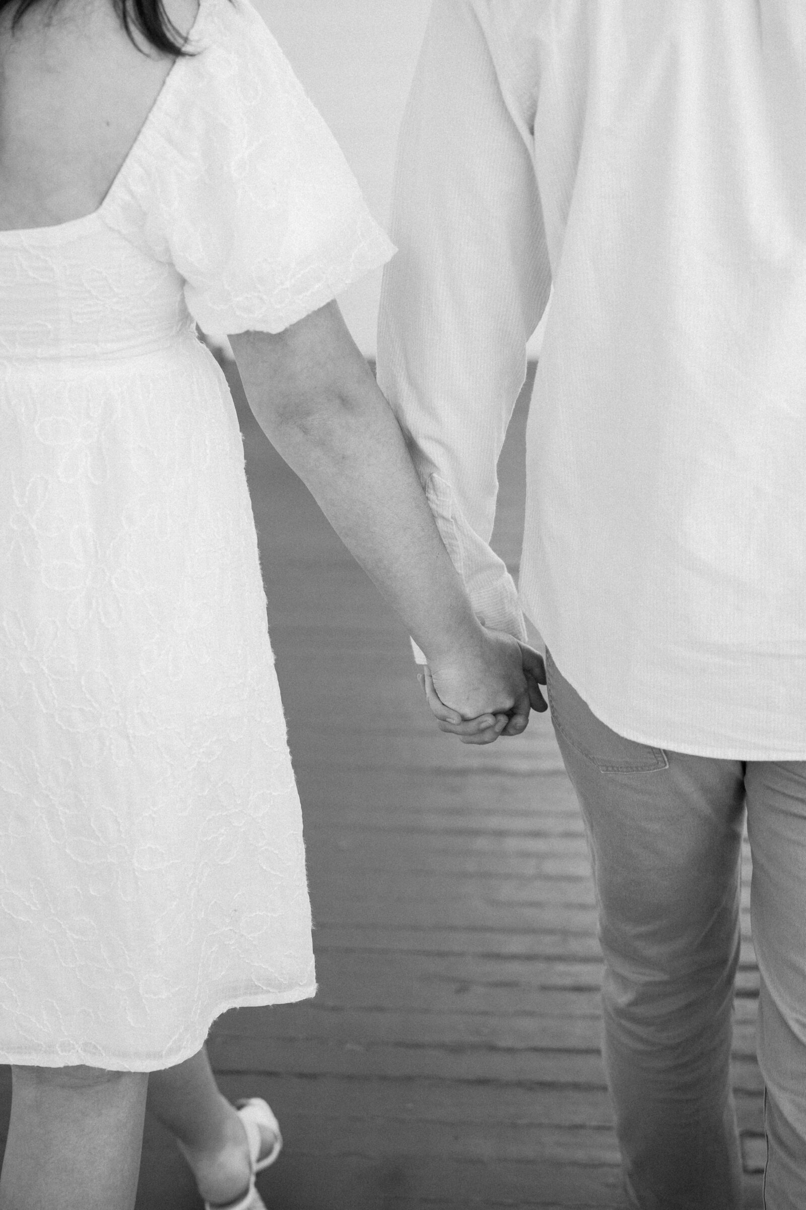 Engagement Session at the VMFA in Richmond VA | black and white closeup picture of couple holding hands while they walk