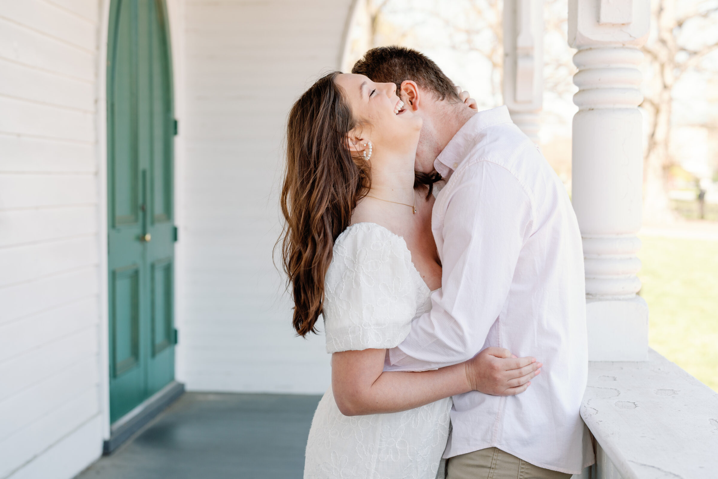 Engagement Session at the VMFA in Richmond VA | guy kisses his fiancee's neck as she laughs
