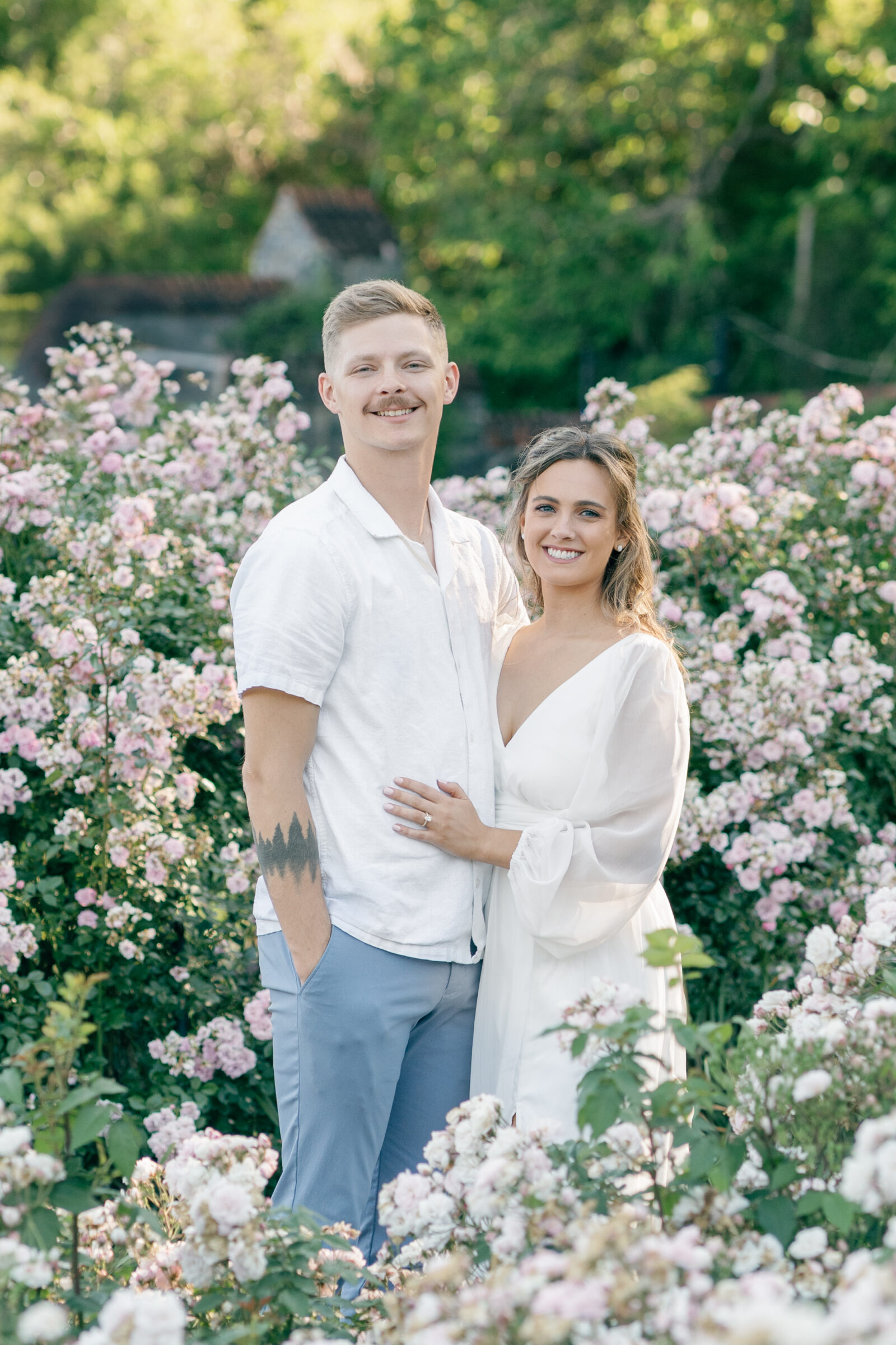 Engagement Photos at the Biltmore Estate Gardens | couple smiles at camera while in the garden