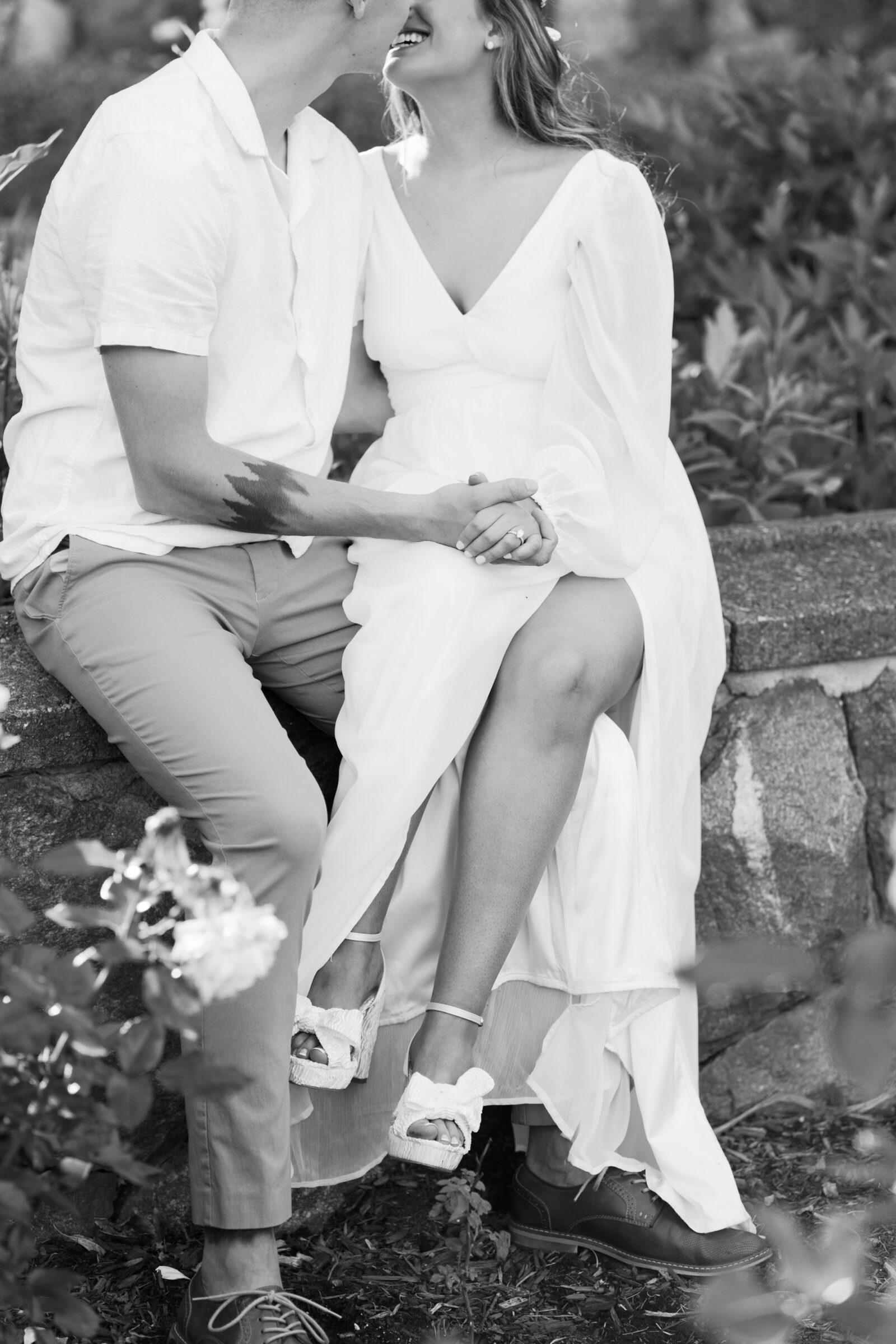 Engagement Photos at the Biltmore Estate Gardens | couple sitting together on garden wall