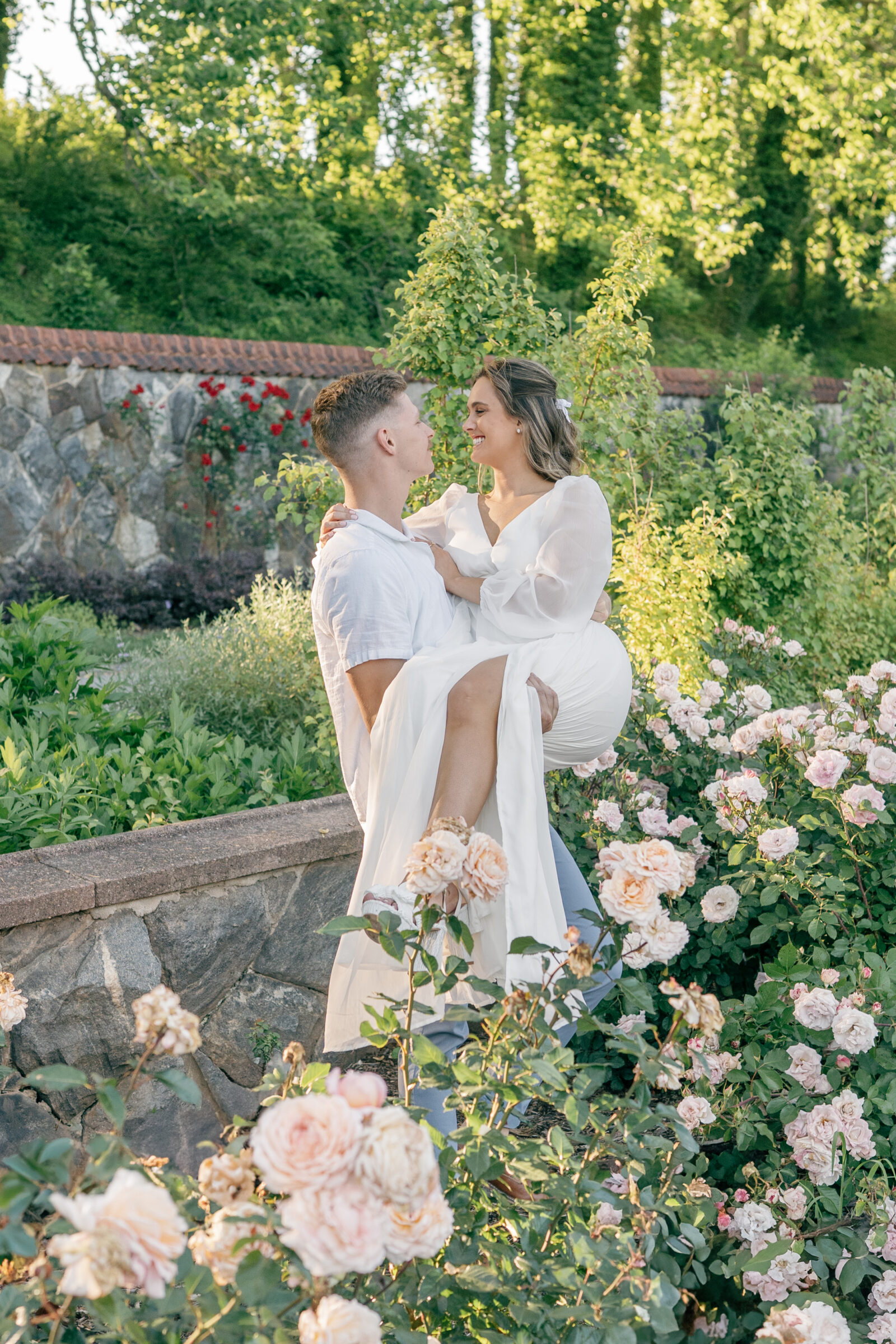 Engagement Photos at the Biltmore Estate Gardens | guy carries girl through garden