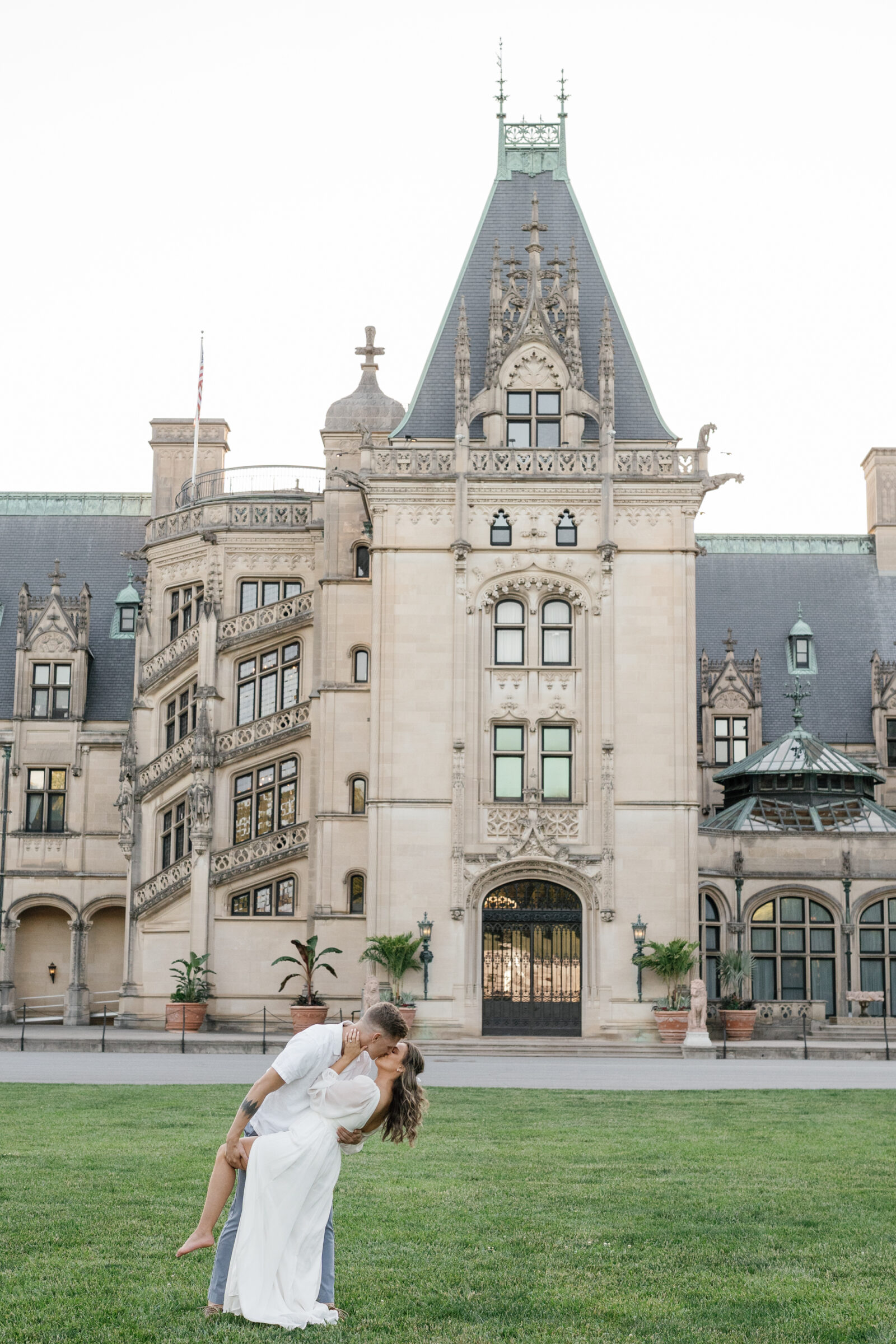 Engagement Photos at the Biltmore Estate House | couple dip in front of Biltmore House