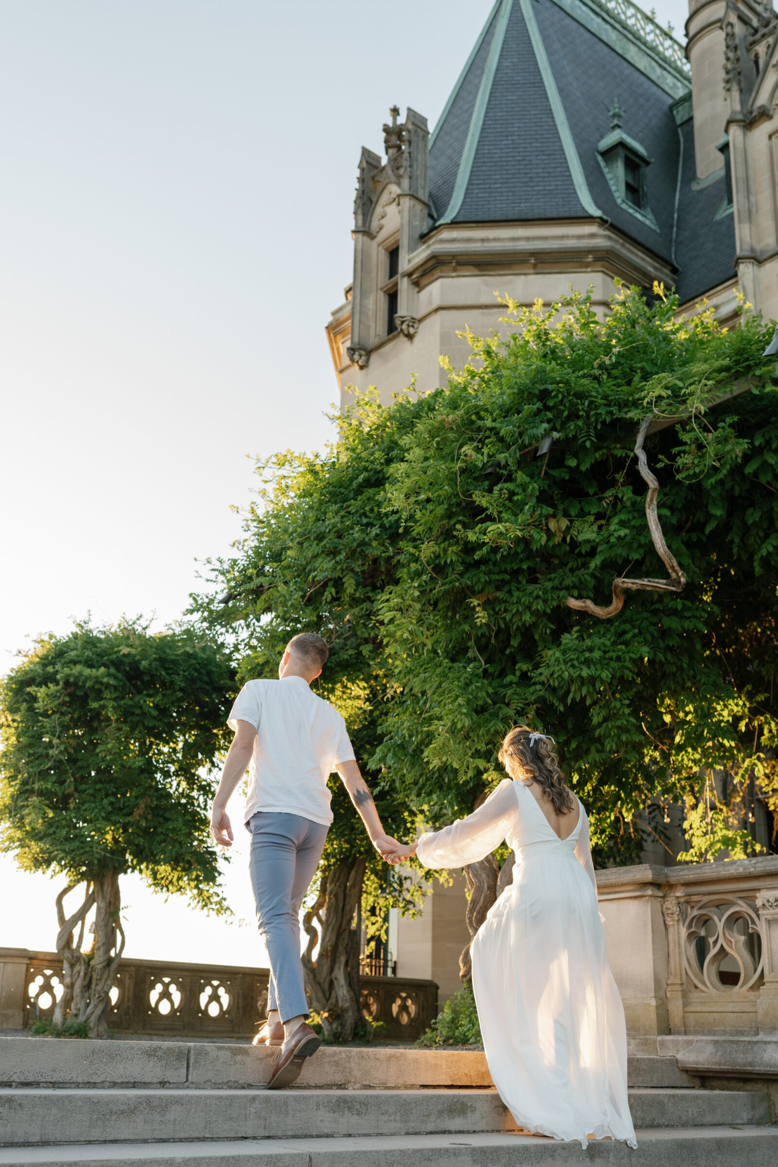 Engagement Photos at the Biltmore Estate | couple walk up the stairs of the Biltmore Estate