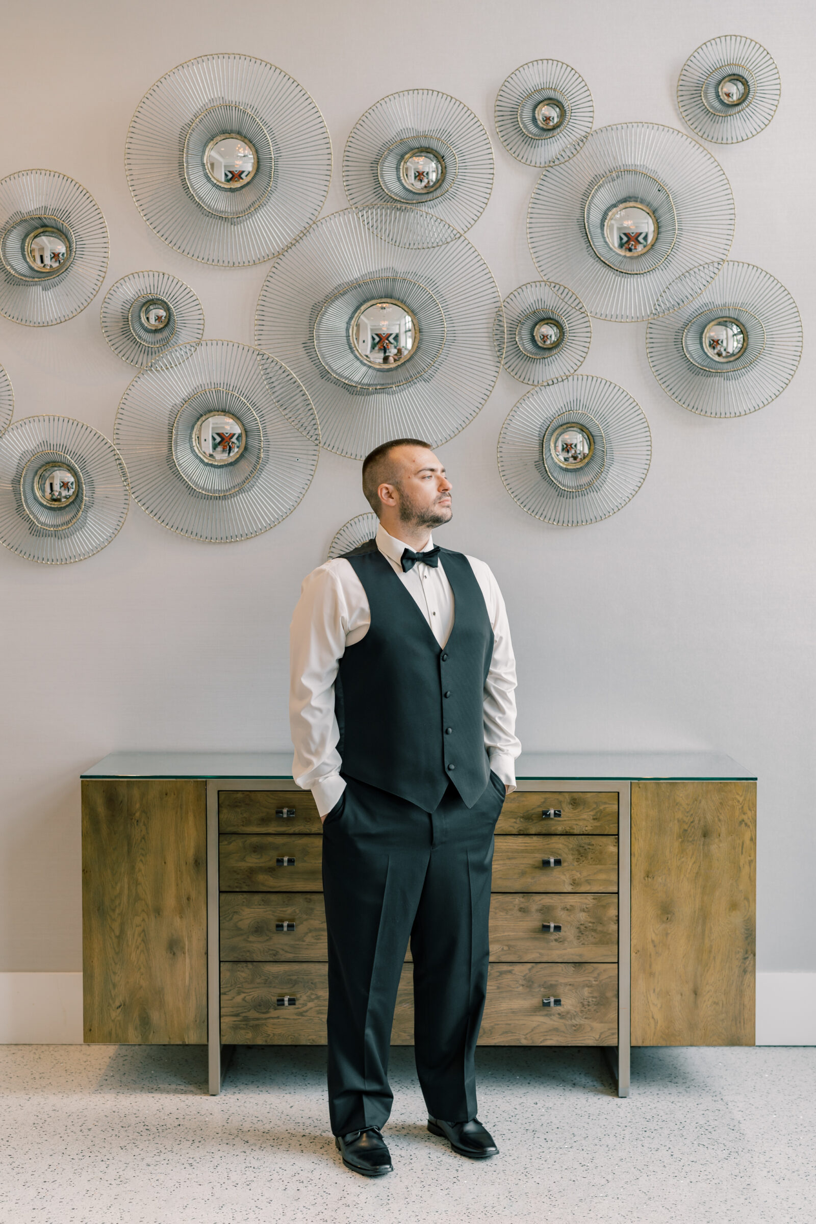 Bristol Hotel Wedding | groom standing in front of a dresser