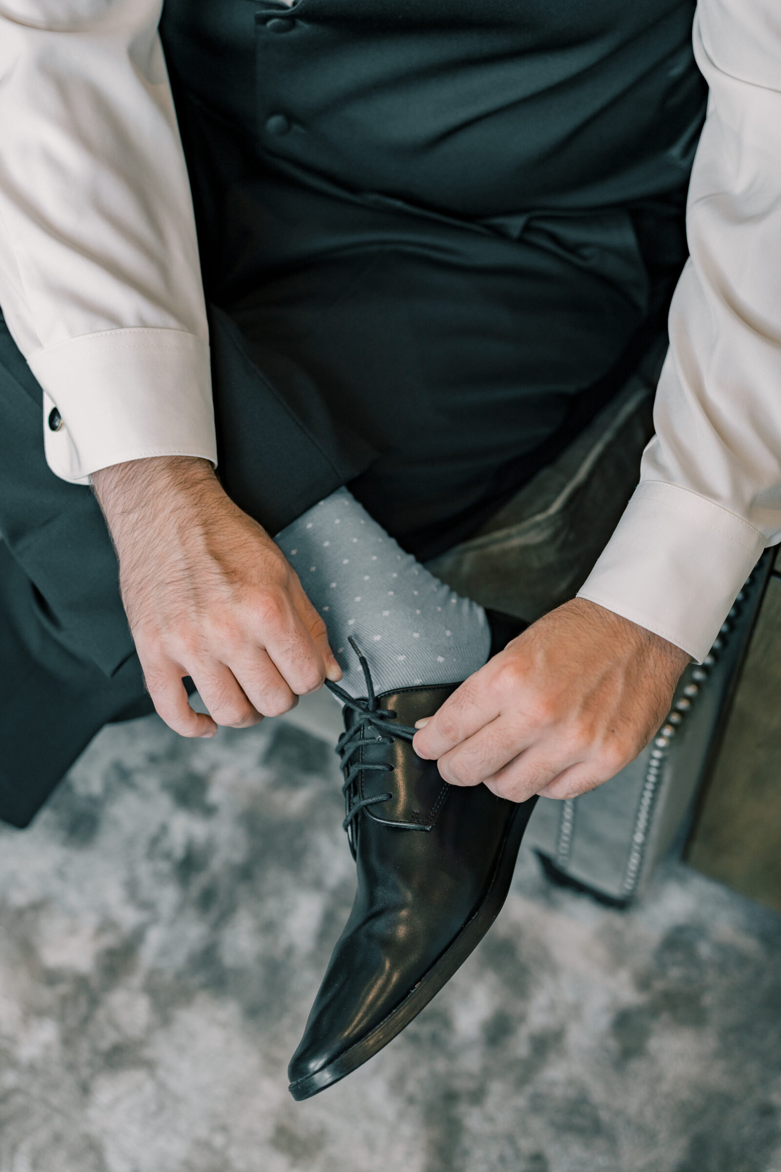Bristol Hotel Wedding | groom puts on shoes