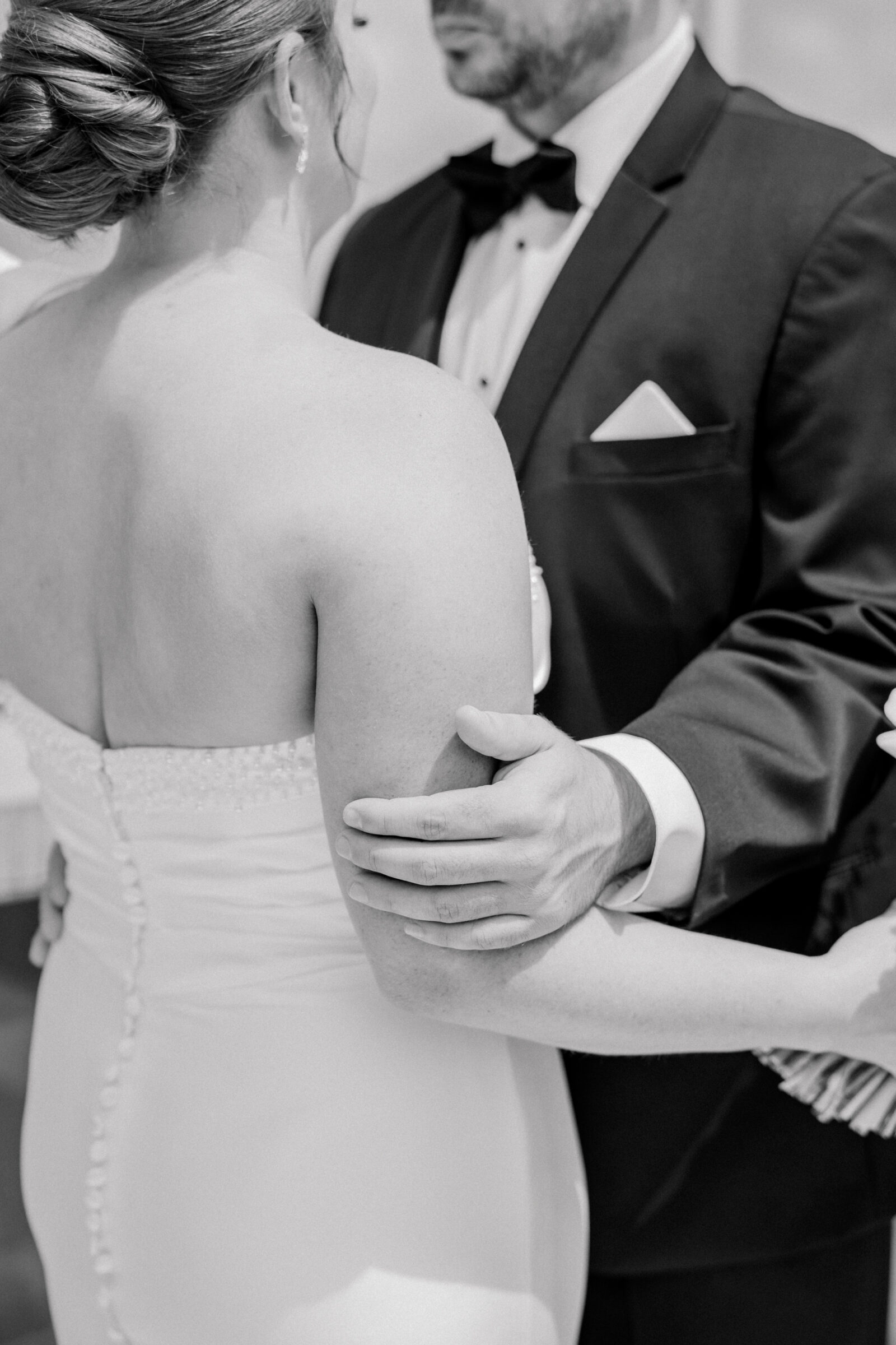 Bristol Hotel Wedding | black and white image of groom's hands resting on bride's arm