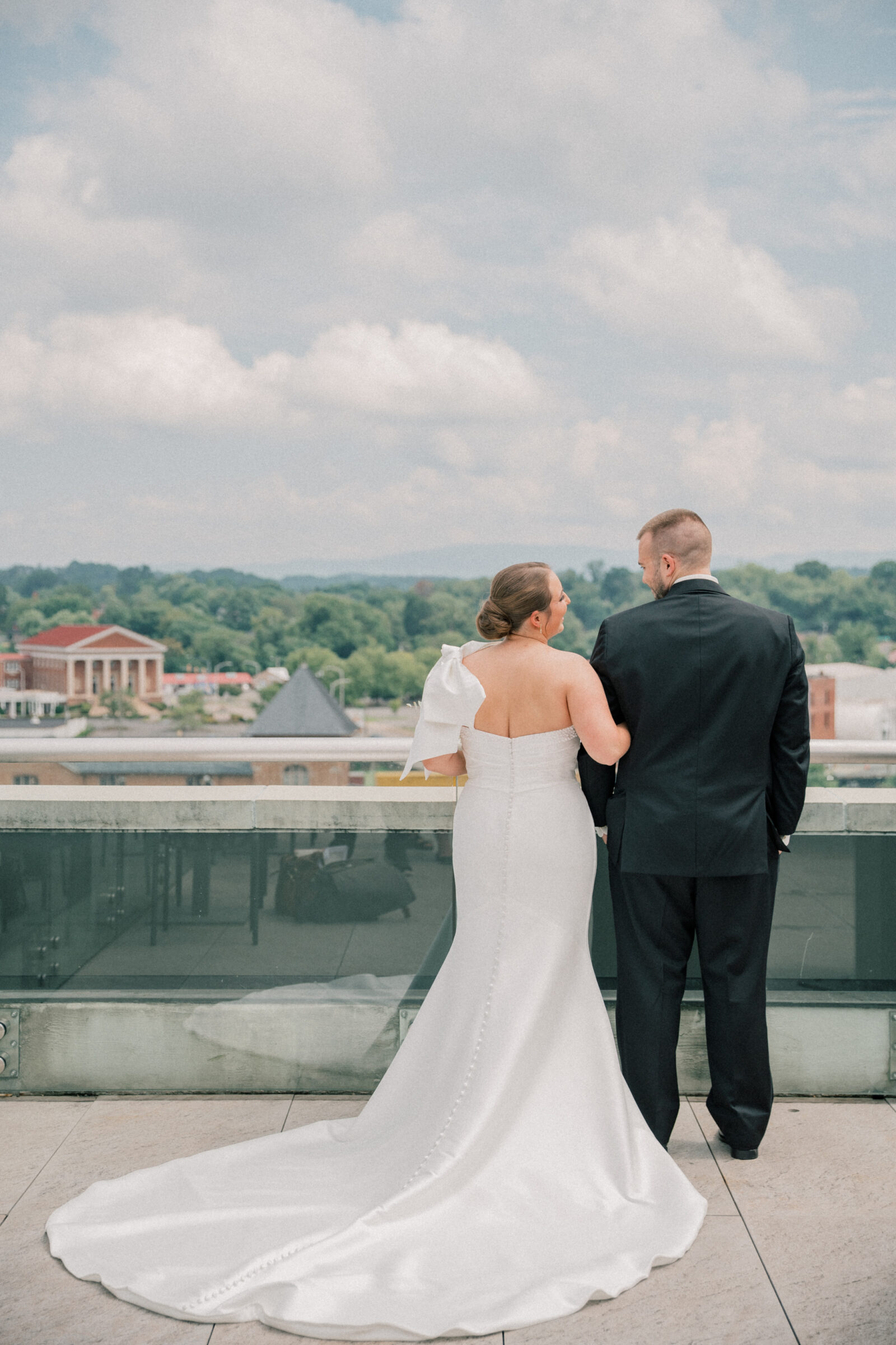 Bristol Hotel Wedding | bride and groom look out over the city together after rooftop first look