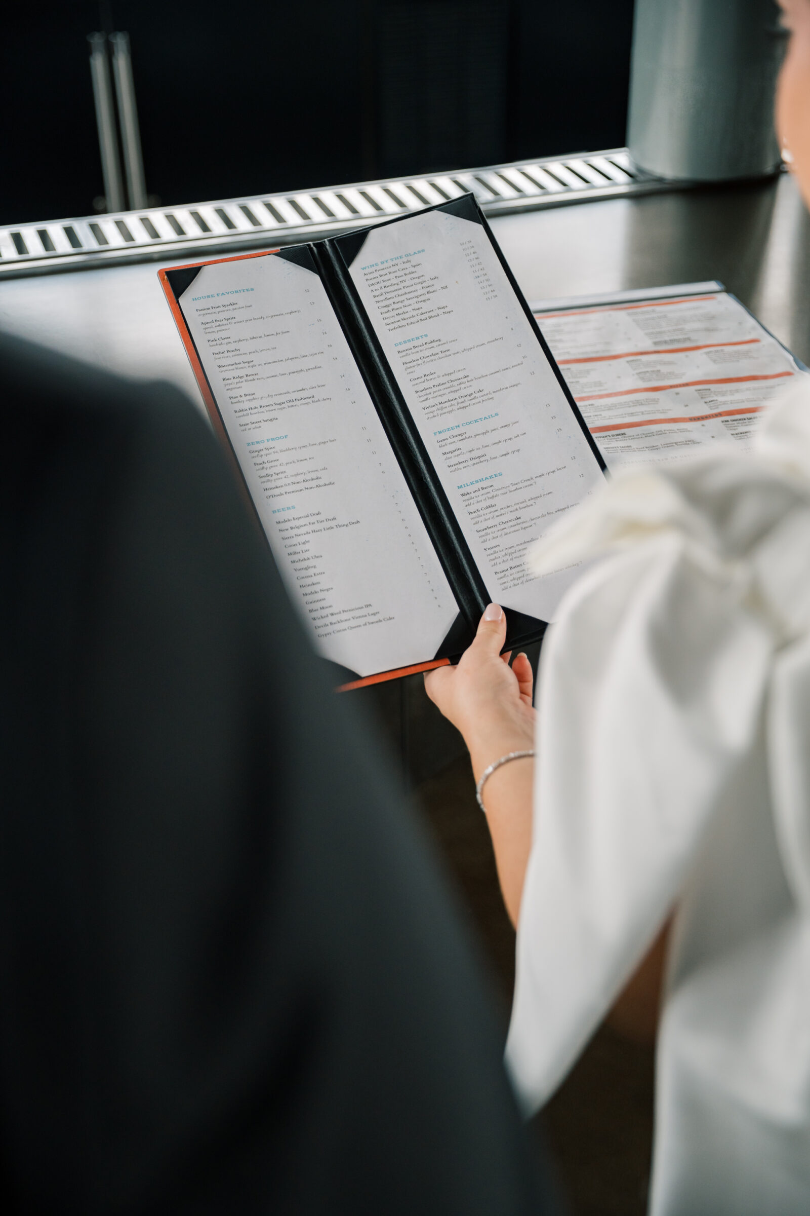 Bristol Hotel Wedding | bride and groom look at menu at Bristol Hotel bar