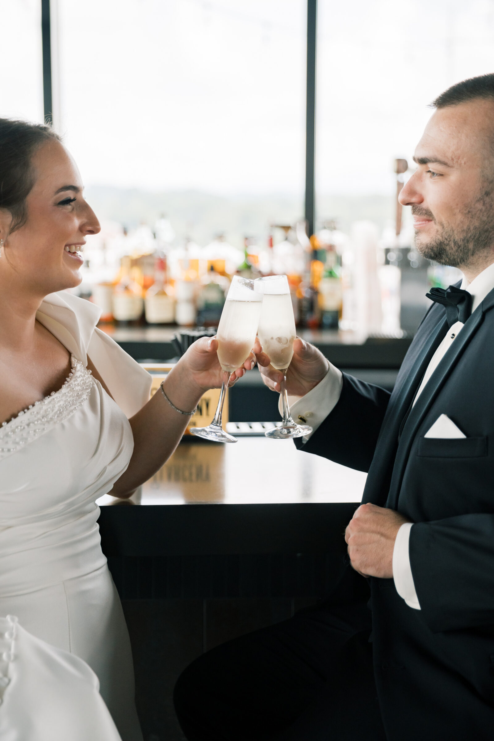 Bristol Hotel Wedding | bride and groom clink glasses in the Bristol Hotel rooftop bar