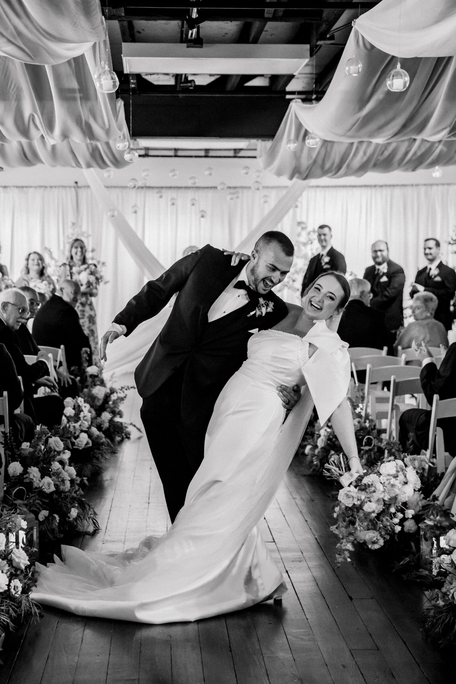 Bristol Train Station Wedding | bride and groom dip as they walk back down the aisle after getting married