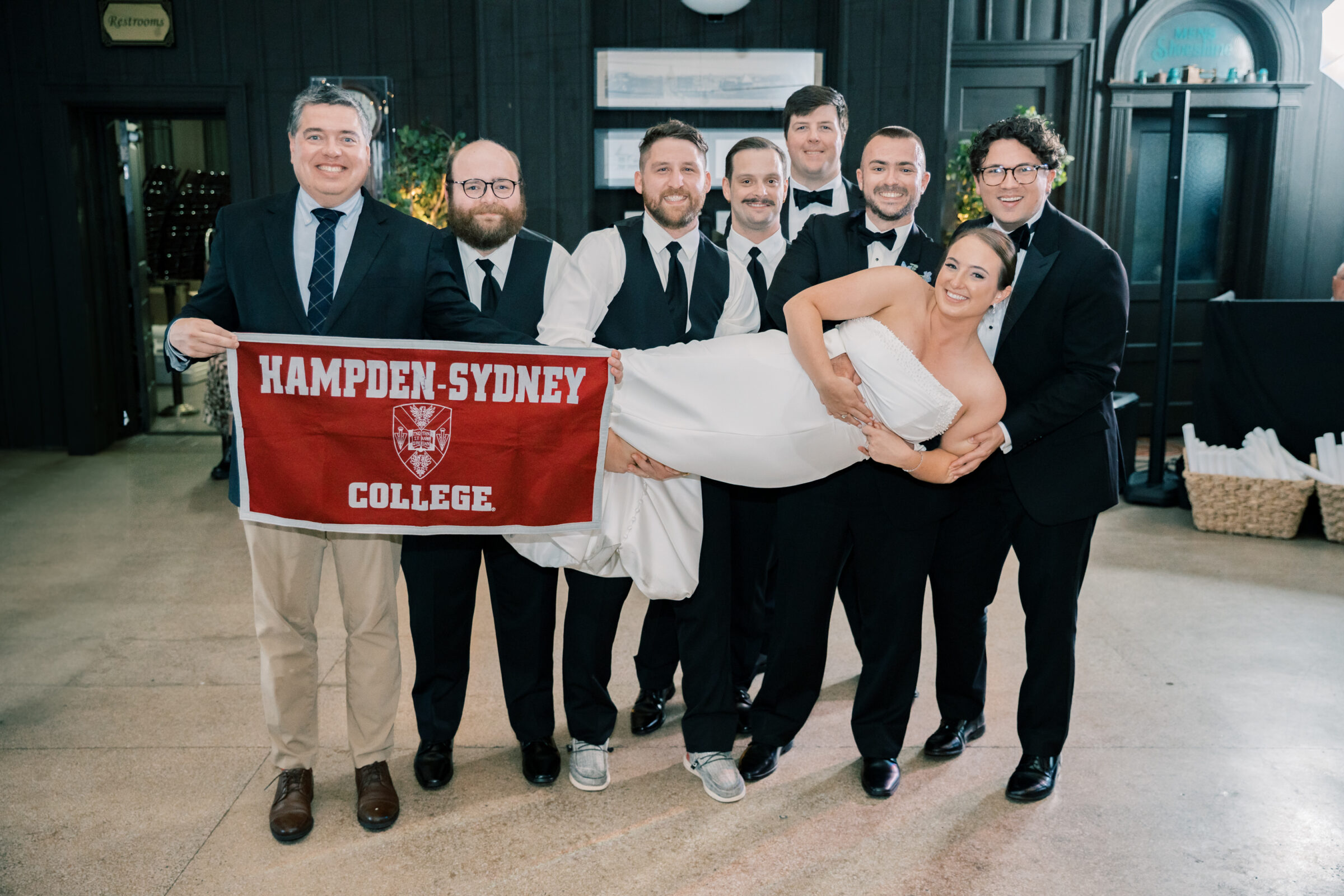 Bristol Train Station Wedding | bride being lifted by college friends at reception