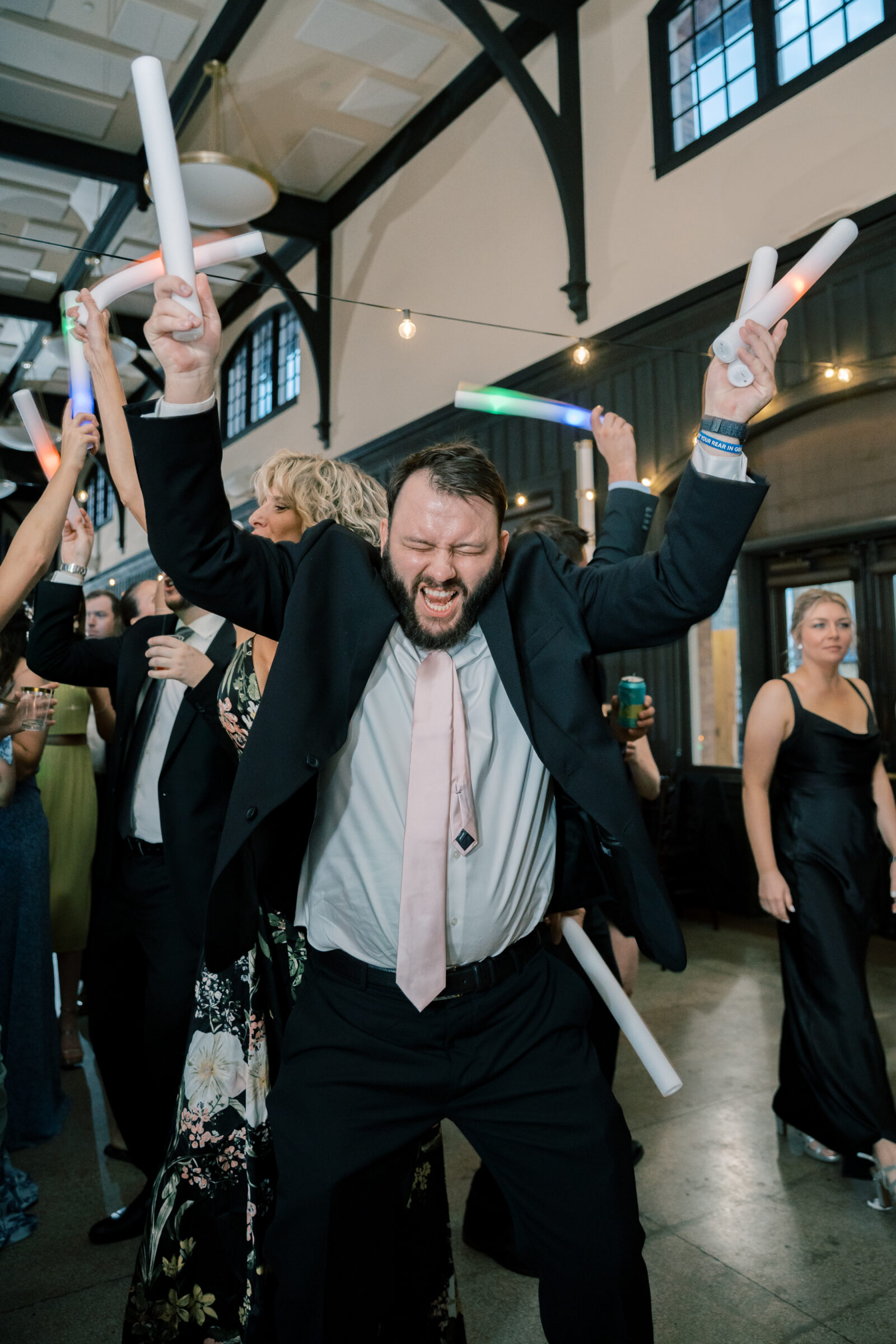 Bristol Train Station Wedding | wedding guest with led foam sticks on dance floor