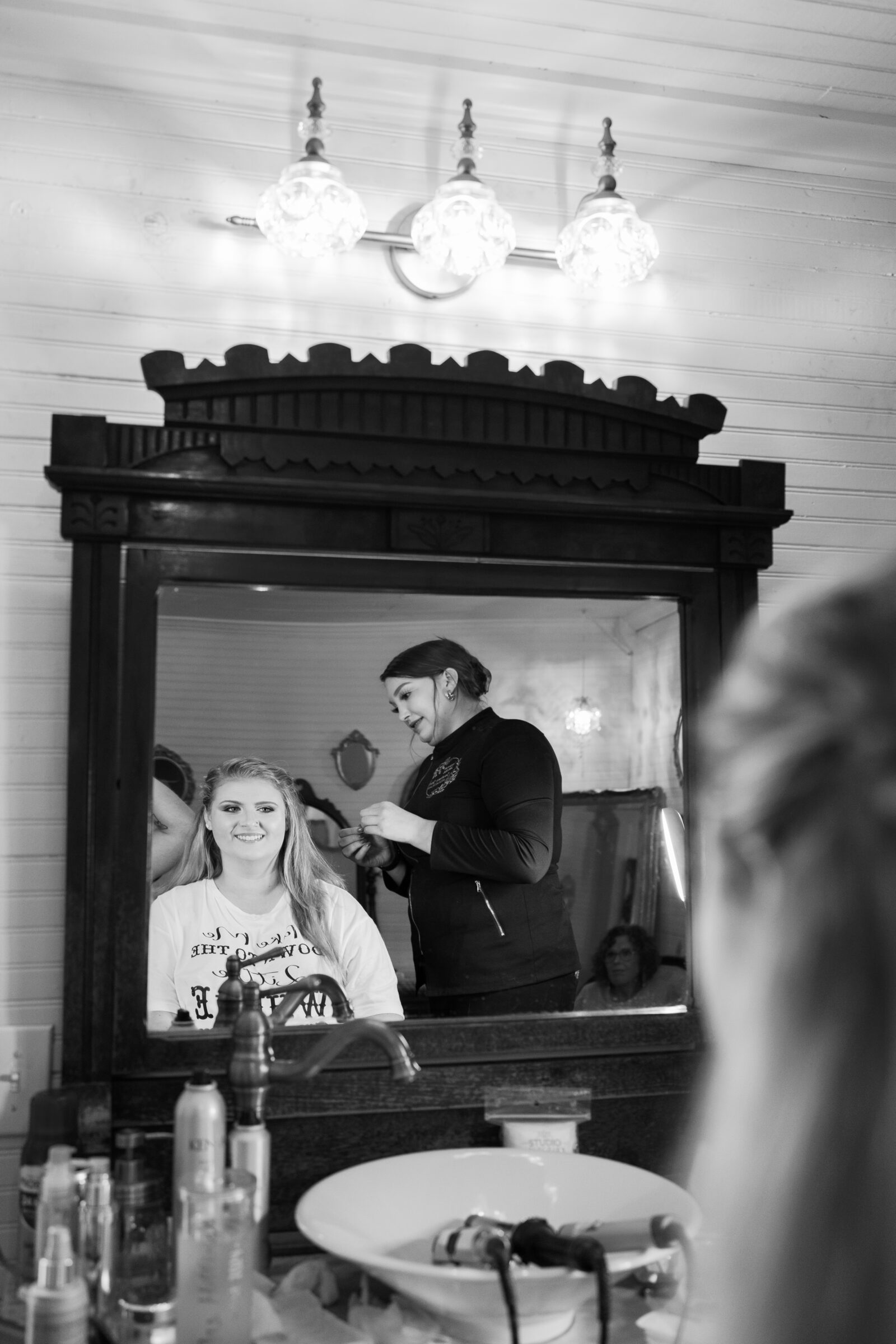 black and white image of bride getting hair done in Full Bloom Farm bridal suite
