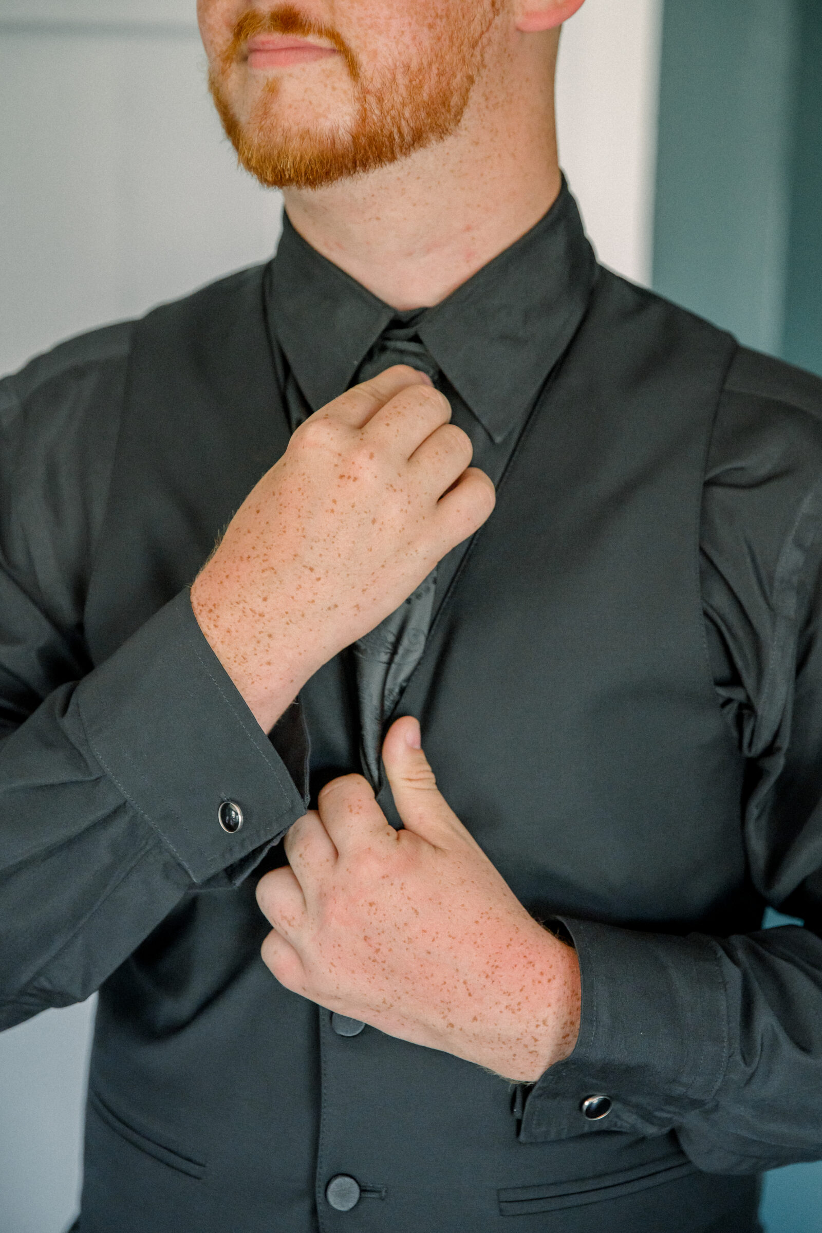 Abingdon VA Wedding Photographer | groom straightens tie before wedding