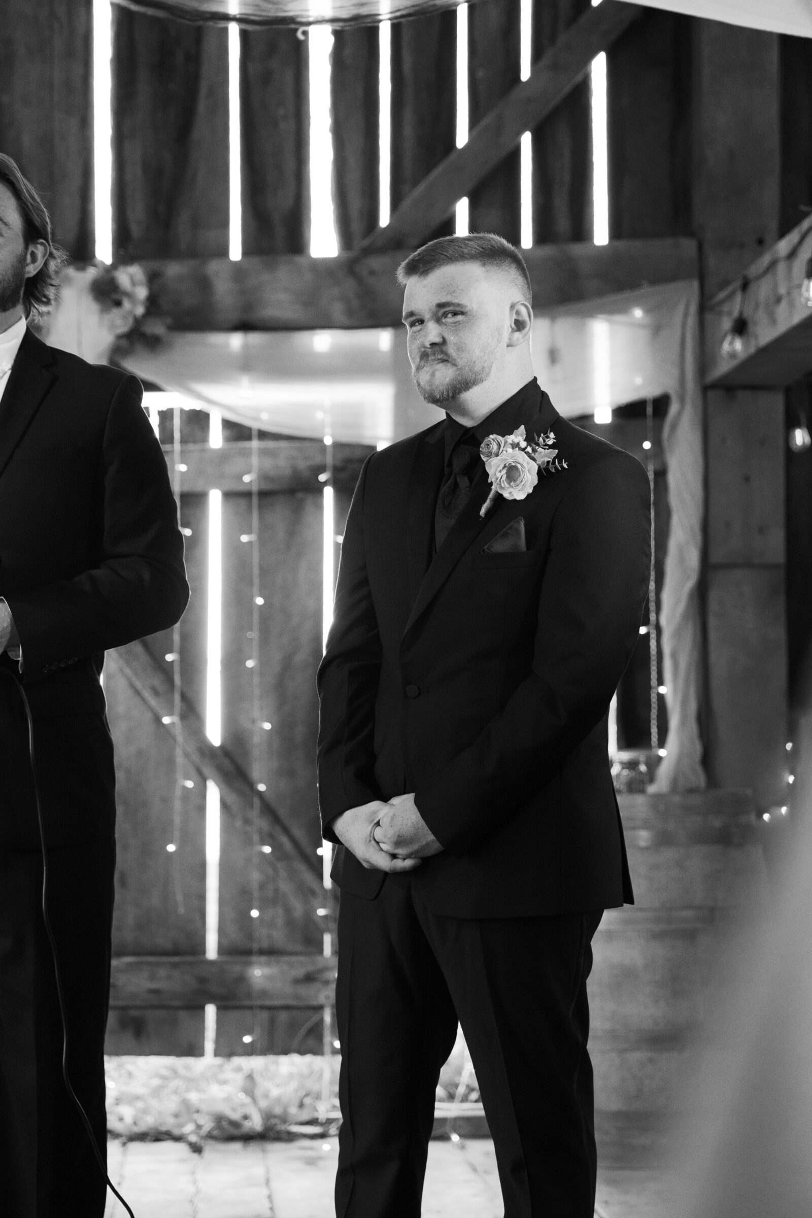 Full Bloom Farm Wedding | black and white image of groom waiting on bride to come down the aisle