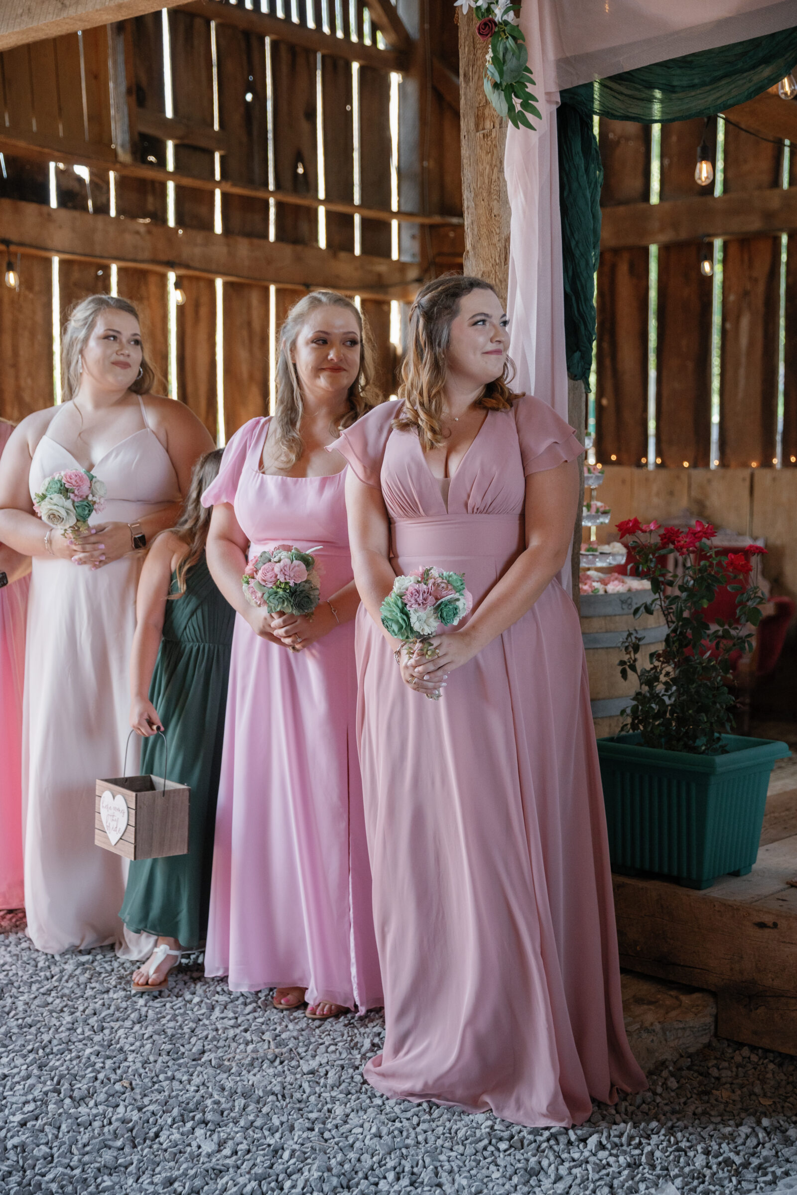 Full Bloom Farm Wedding | bridesmaids in pink dresses watch ceremony lovingly