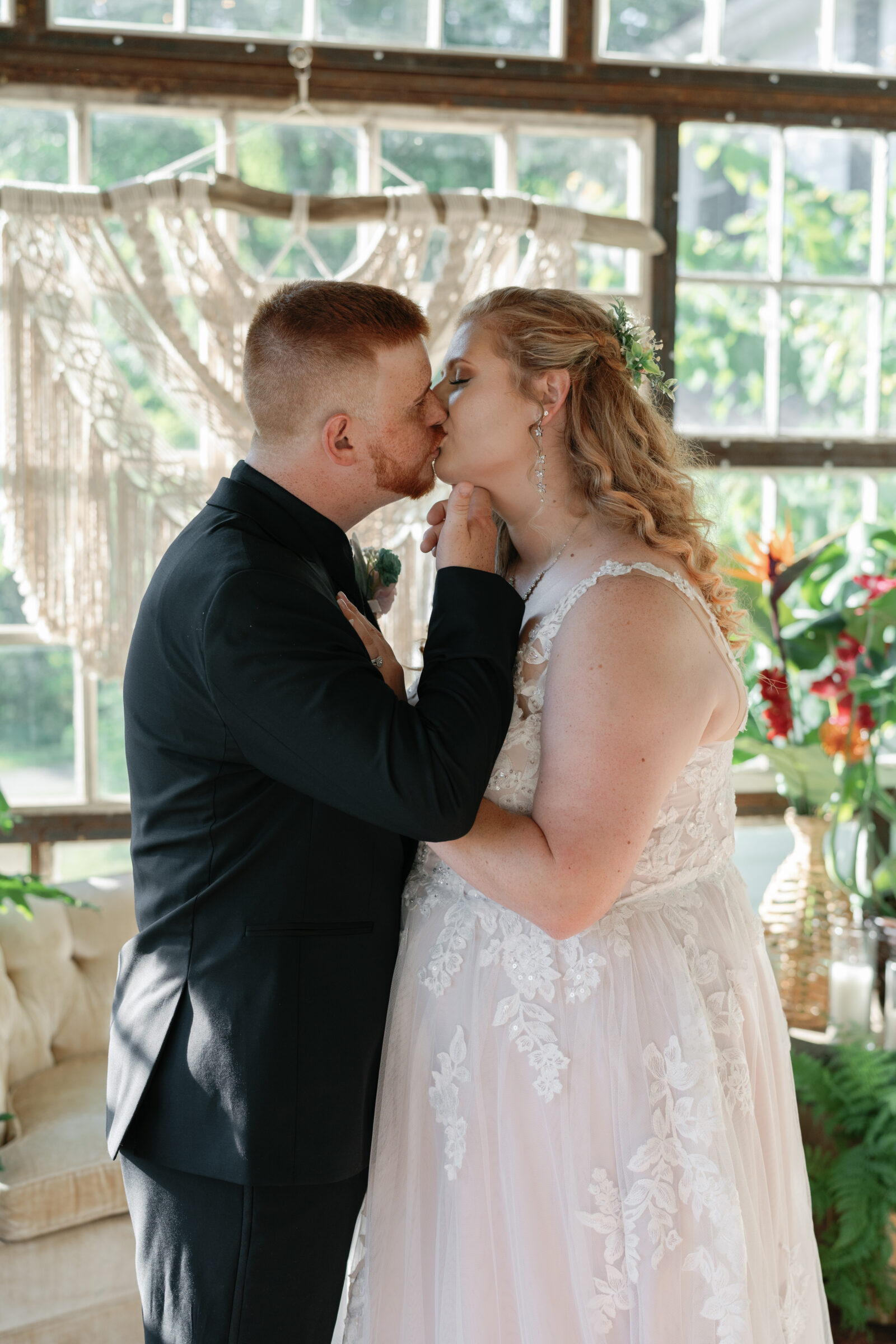Full Bloom Farm Wedding | bride and groom share kiss in the greenhouse
