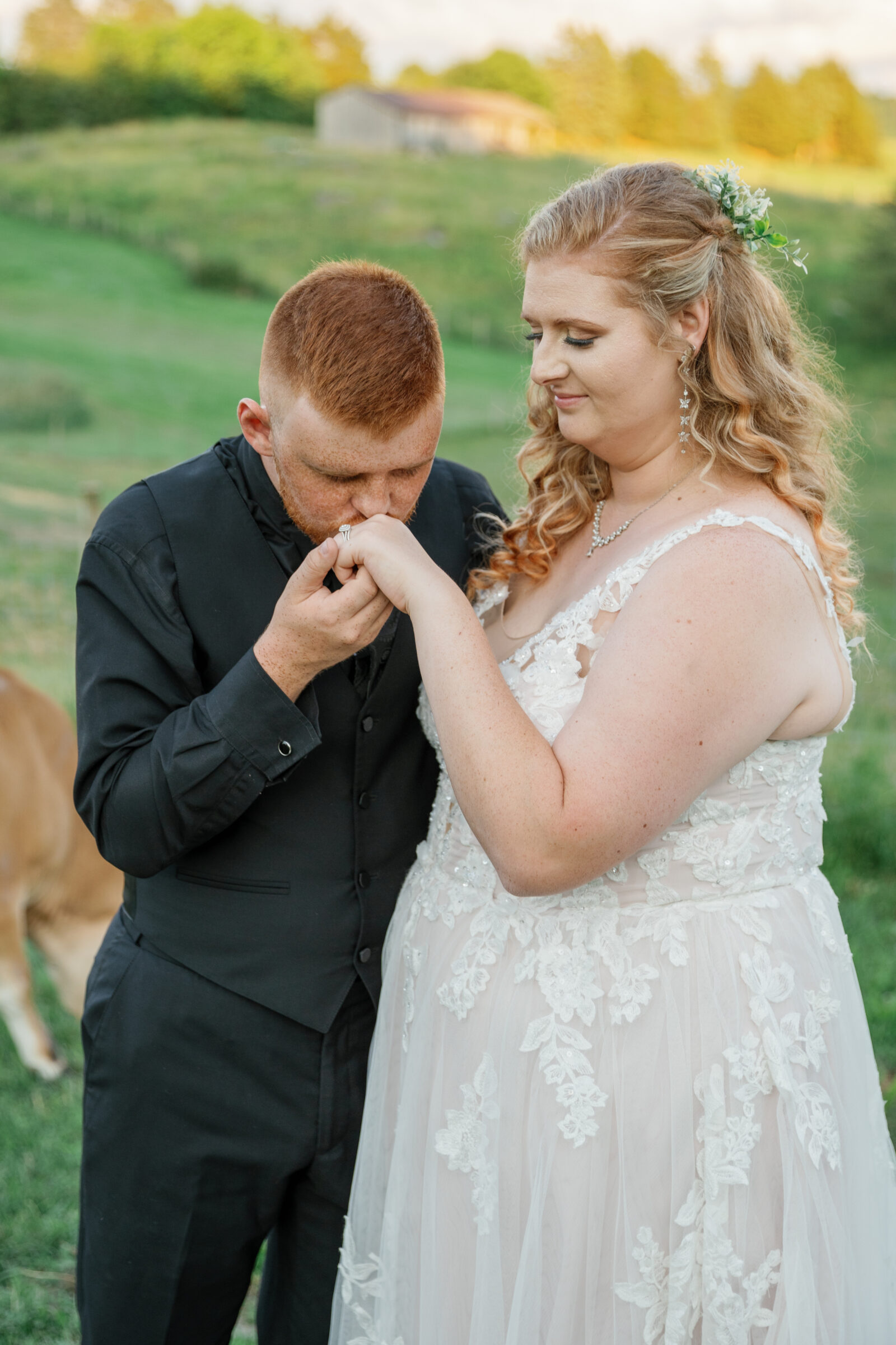 Full Bloom Farm Wedding | groom raises bride's hand up for a kiss